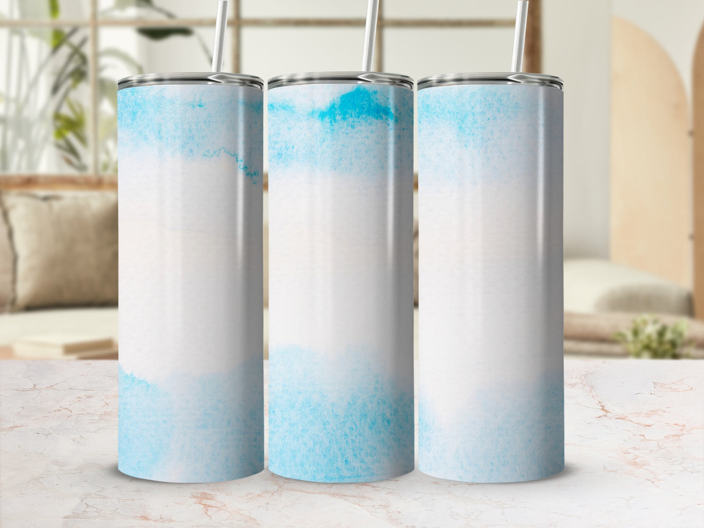 Three blue watercolor tumblers with straws, side by side.