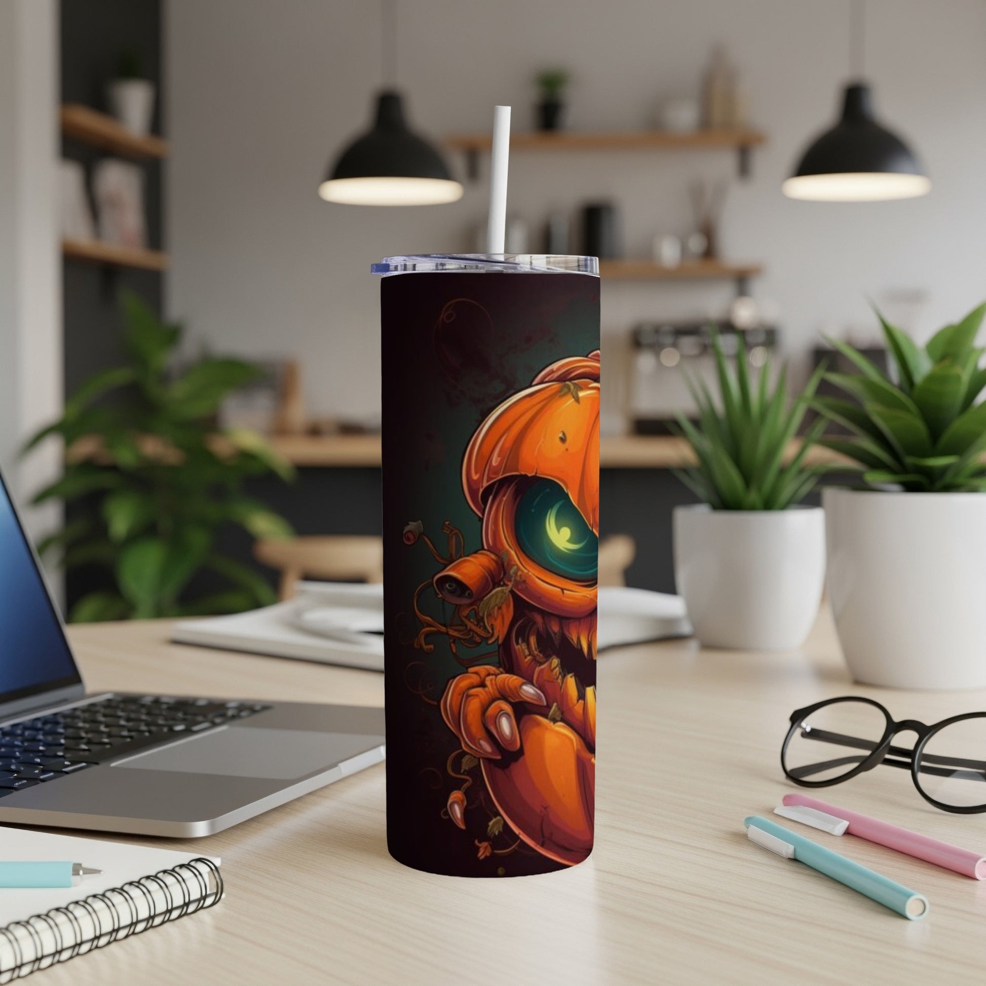 Tall tumbler with a spooky jack-o'-lantern illustration and a straw.