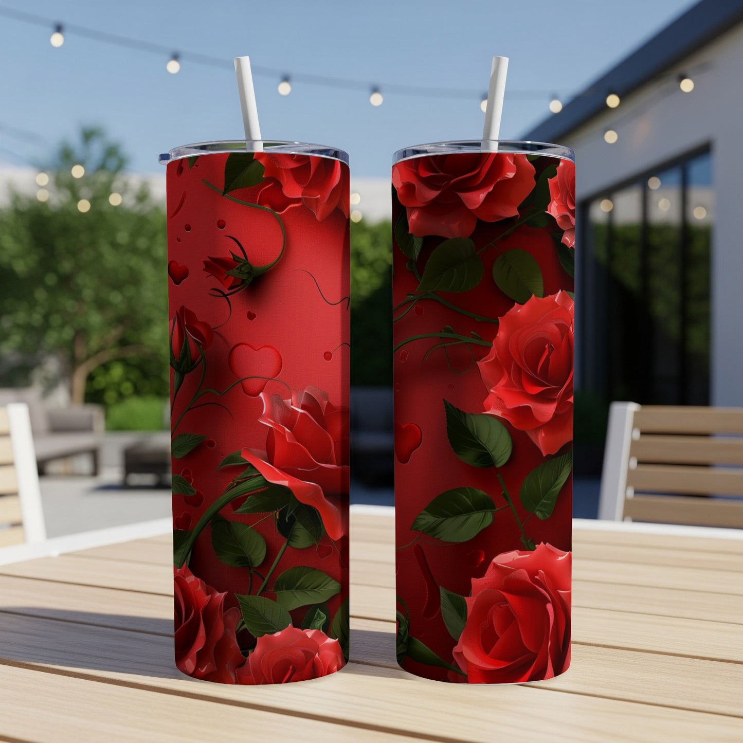 Two red tumblers with a rose and heart pattern on a wooden table.