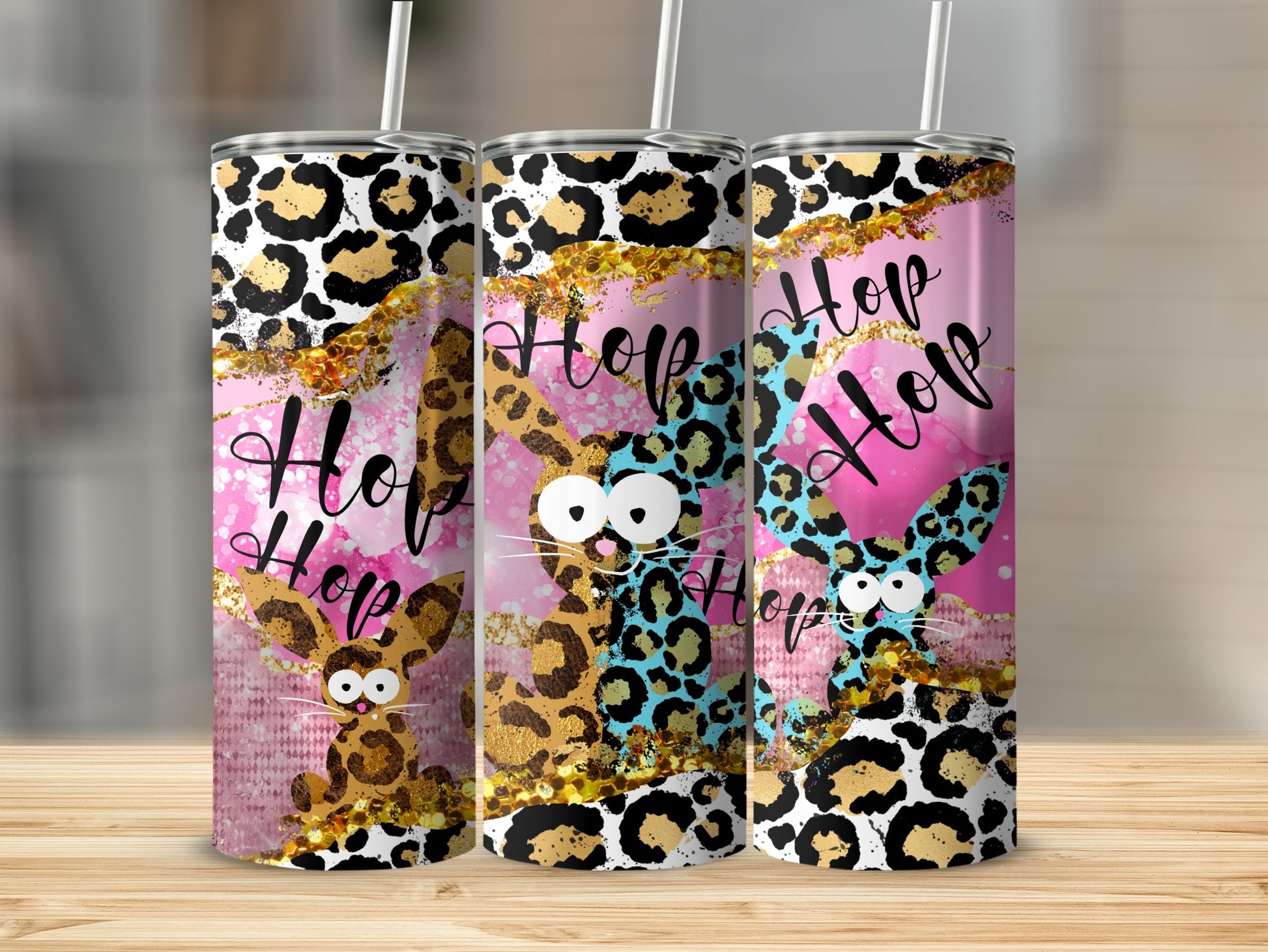 Three tumblers with bunny illustrations, leopard print, and "Hop Hop" text.