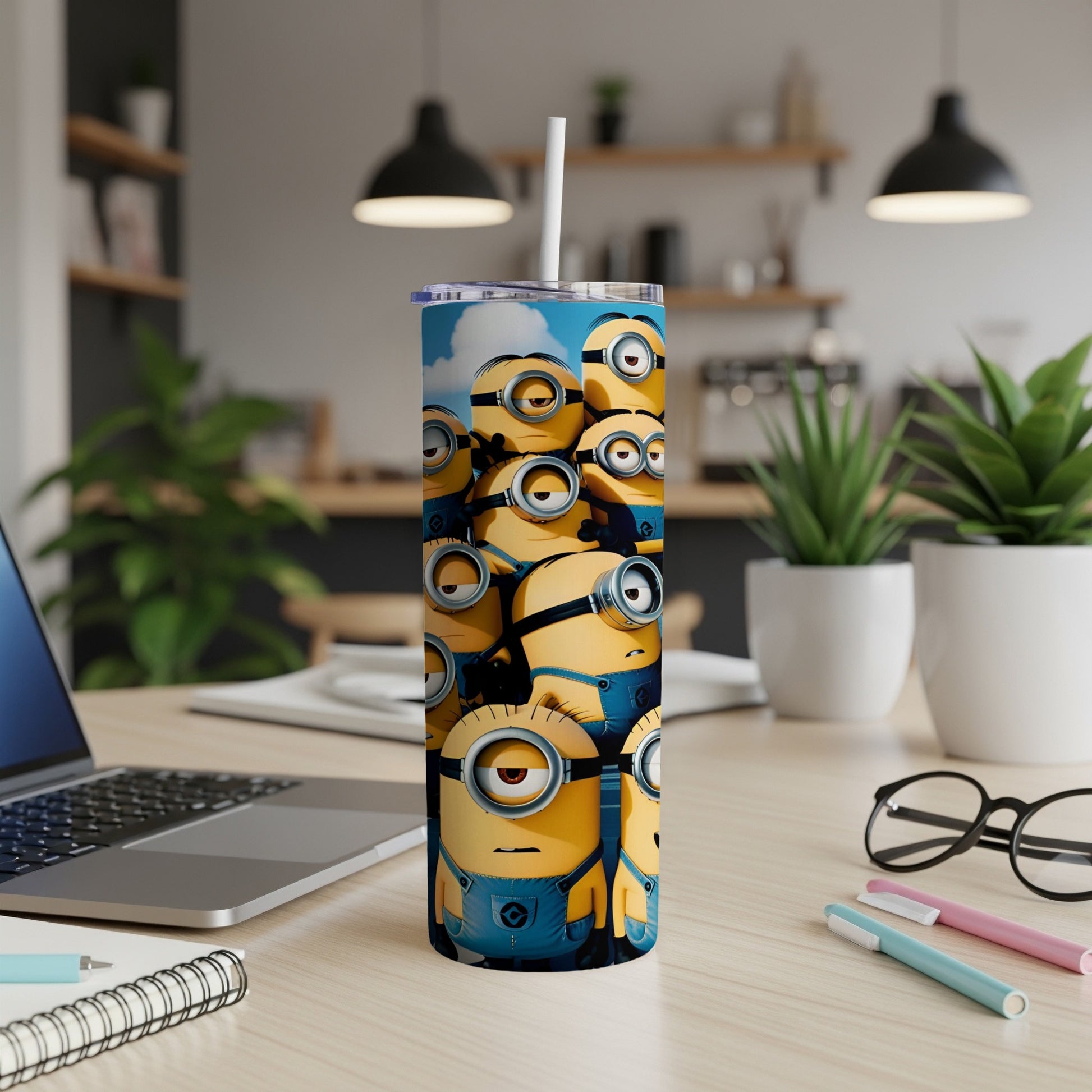 Minions characters on a blue tumbler with a straw, on a desk.