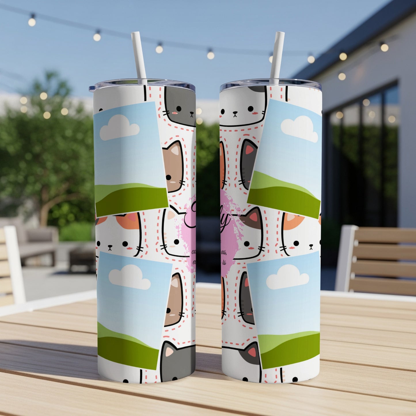 Two tumblers with cartoon cats and clouds on a table outdoors.