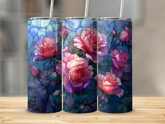 Three tumblers with stained glass rose design on a wooden surface.