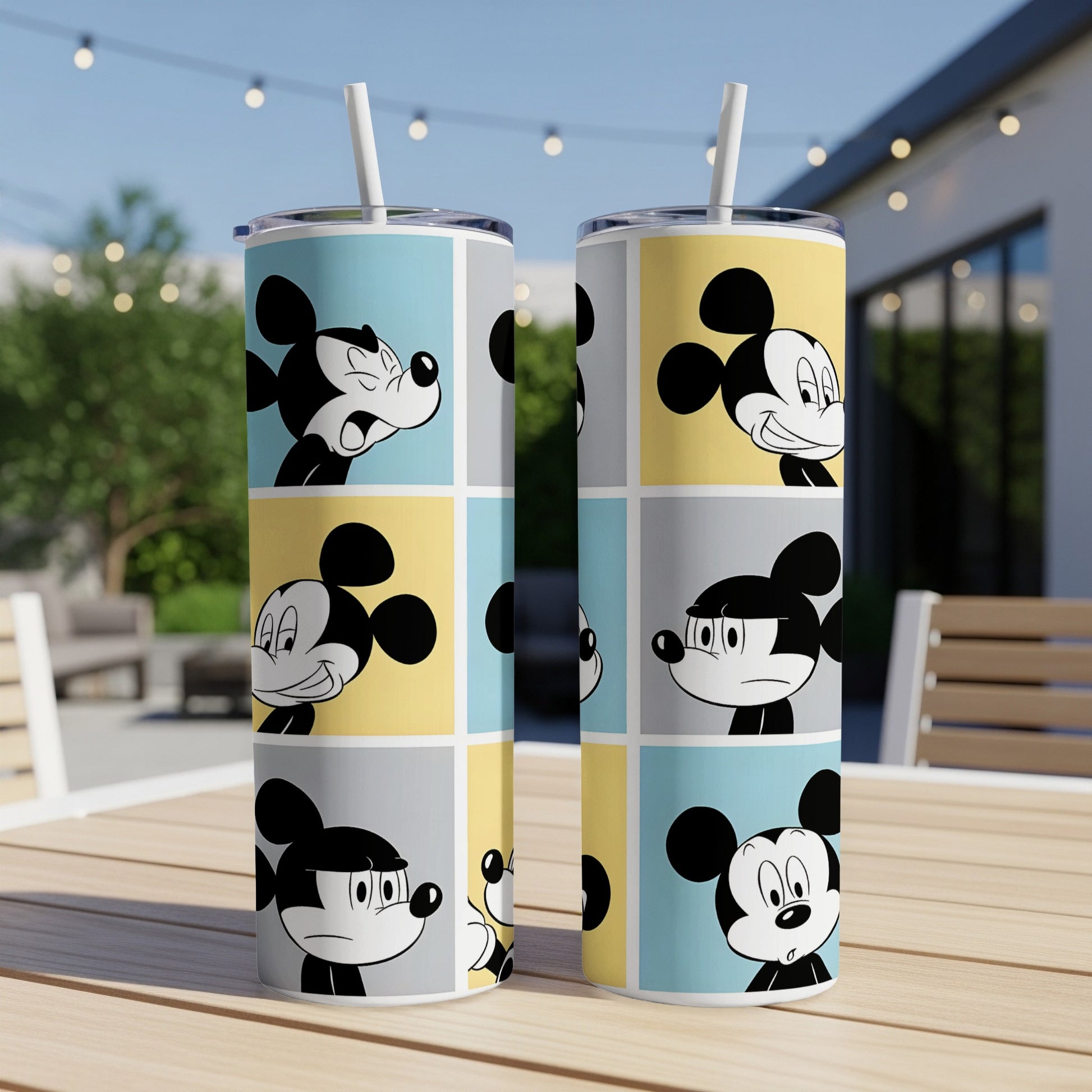 Mickey Mouse faces in colorful comic panels on two tall tumblers.
