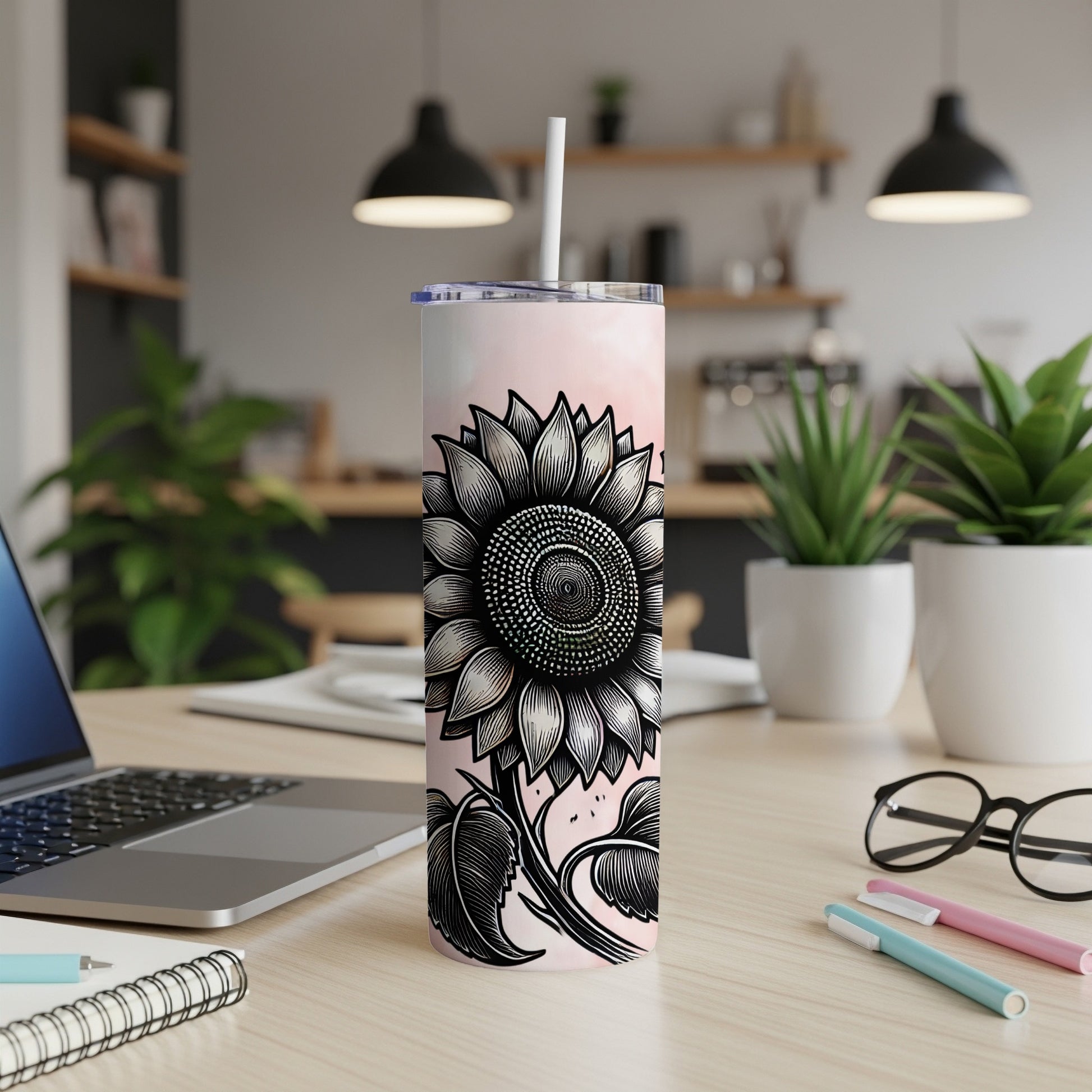 Tall tumbler with a black and white sunflower design on a pink gradient background.