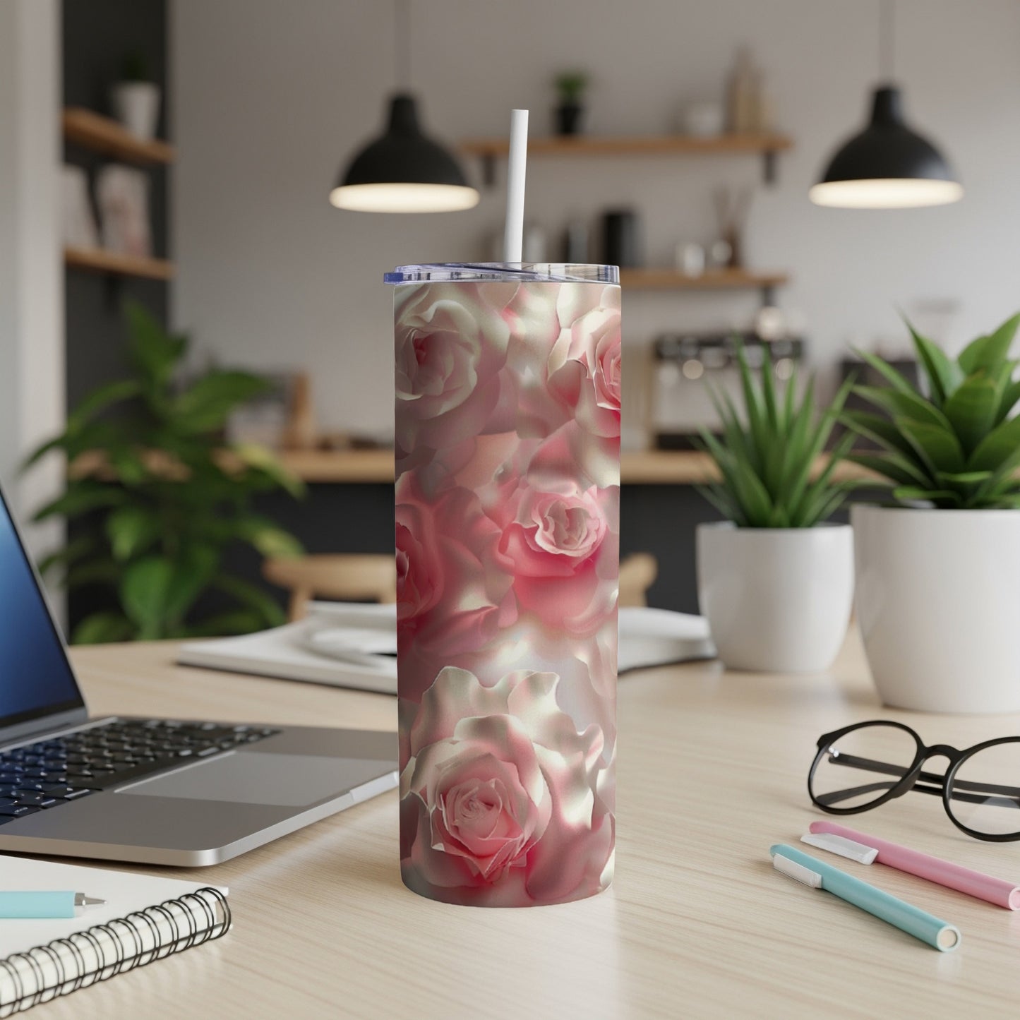Pink and white roses pattern on a skinny tumbler with a straw.