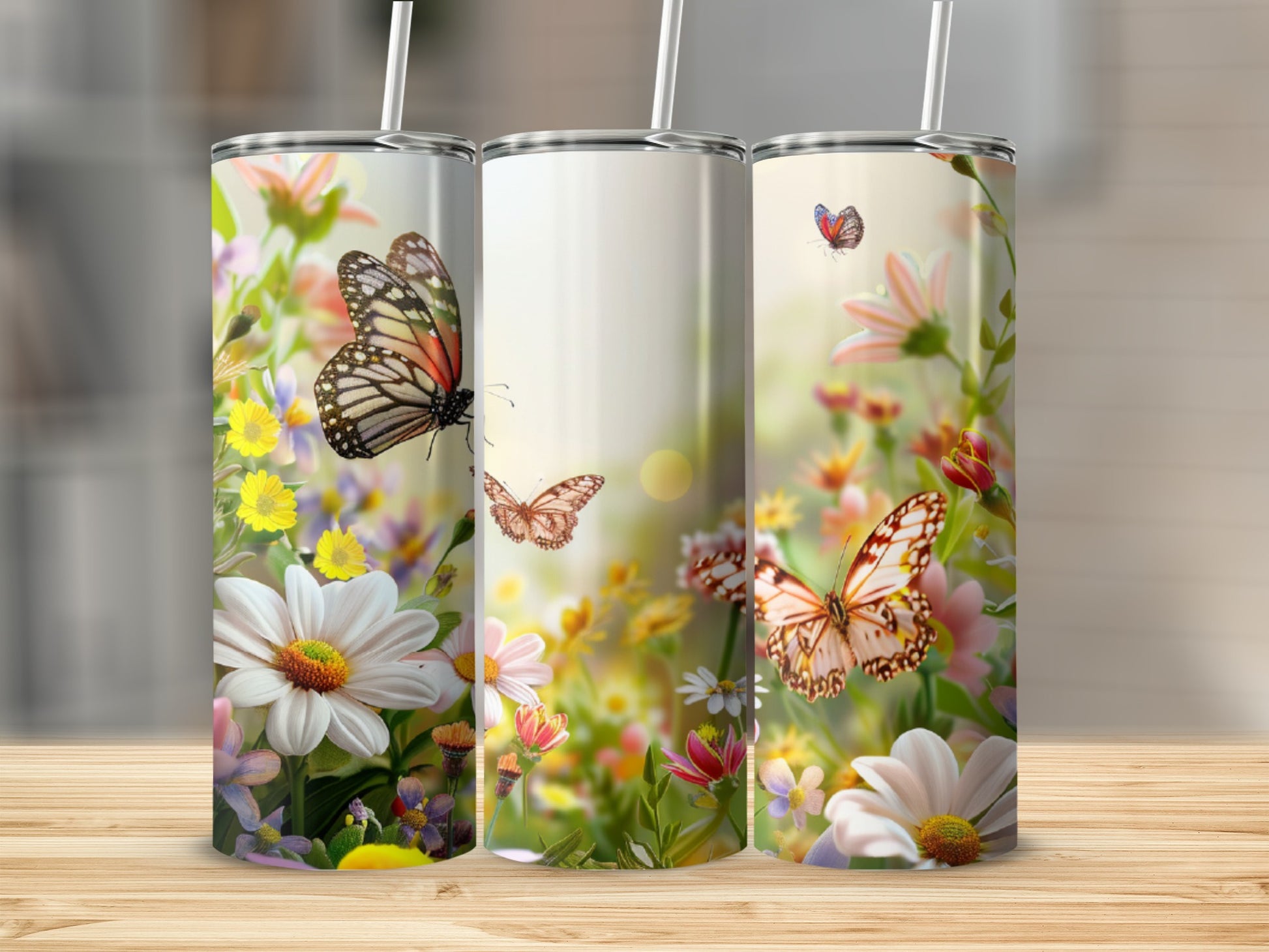 Three tumblers with butterflies and flowers.
