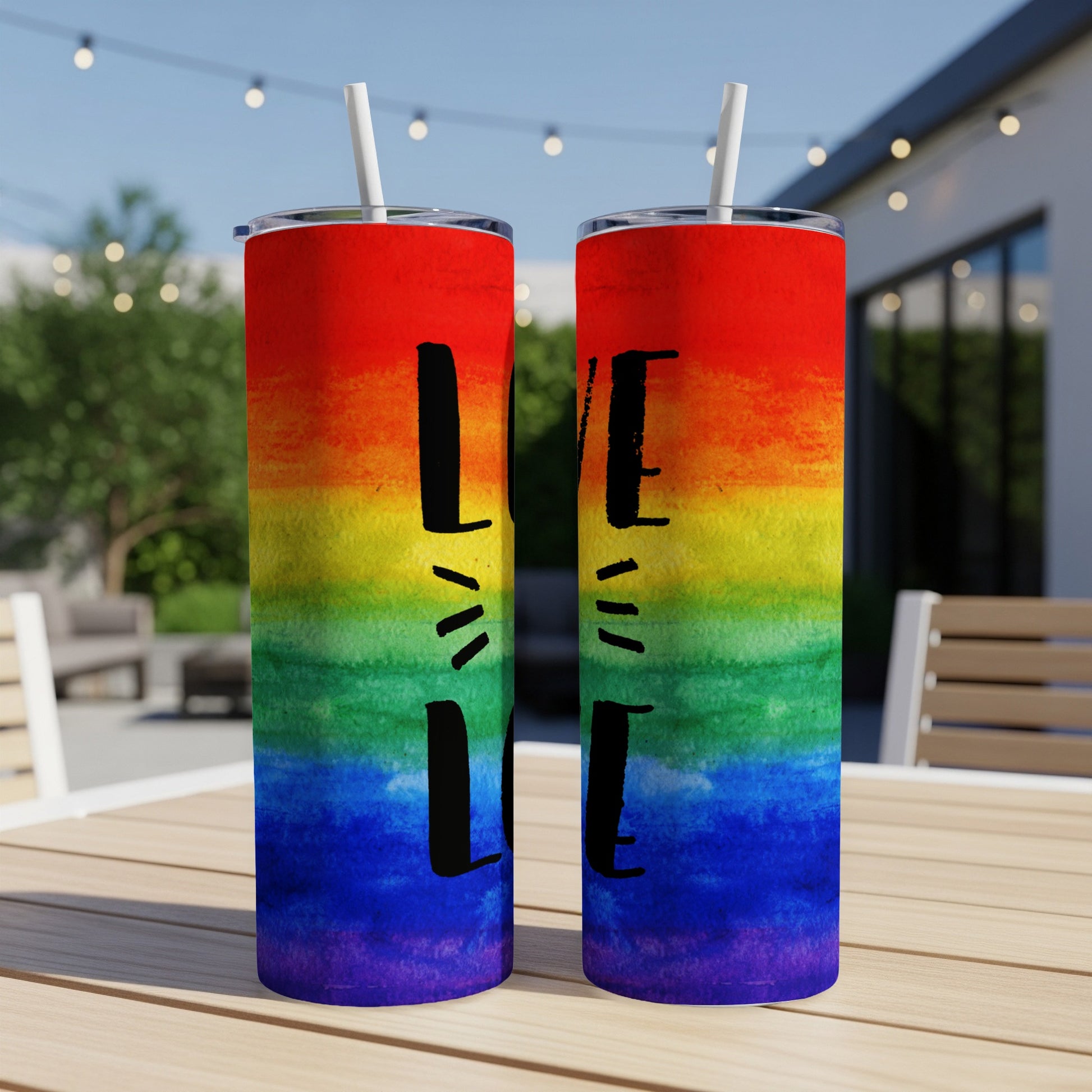 Two rainbow-striped tumblers with "LOVE" text, outdoors.