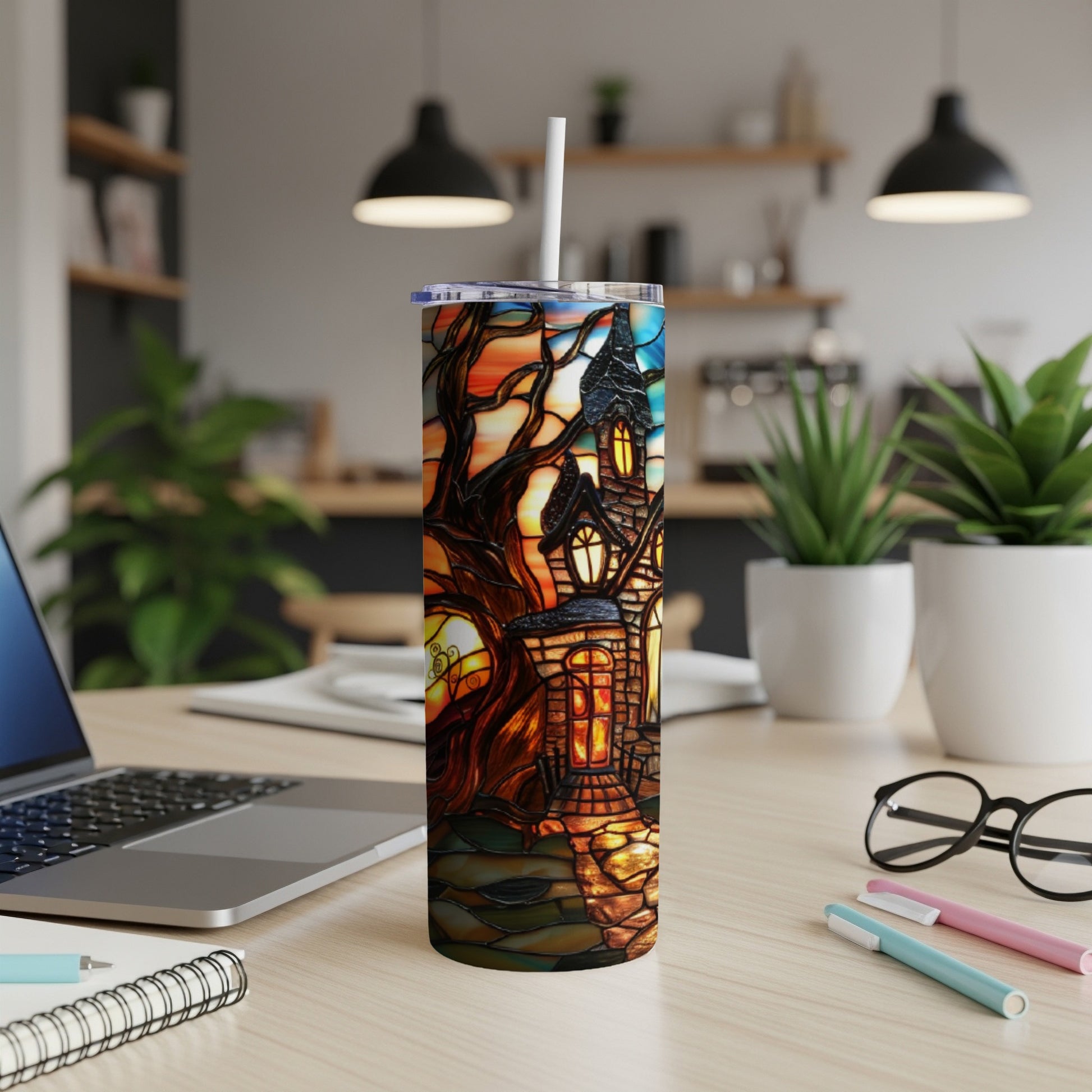 Stained glass tumbler featuring a spooky haunted house and tree design.