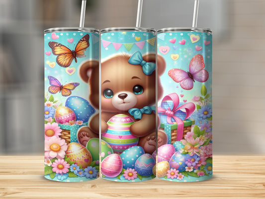 Brown teddy bear holding Easter egg with butterflies and flowers.