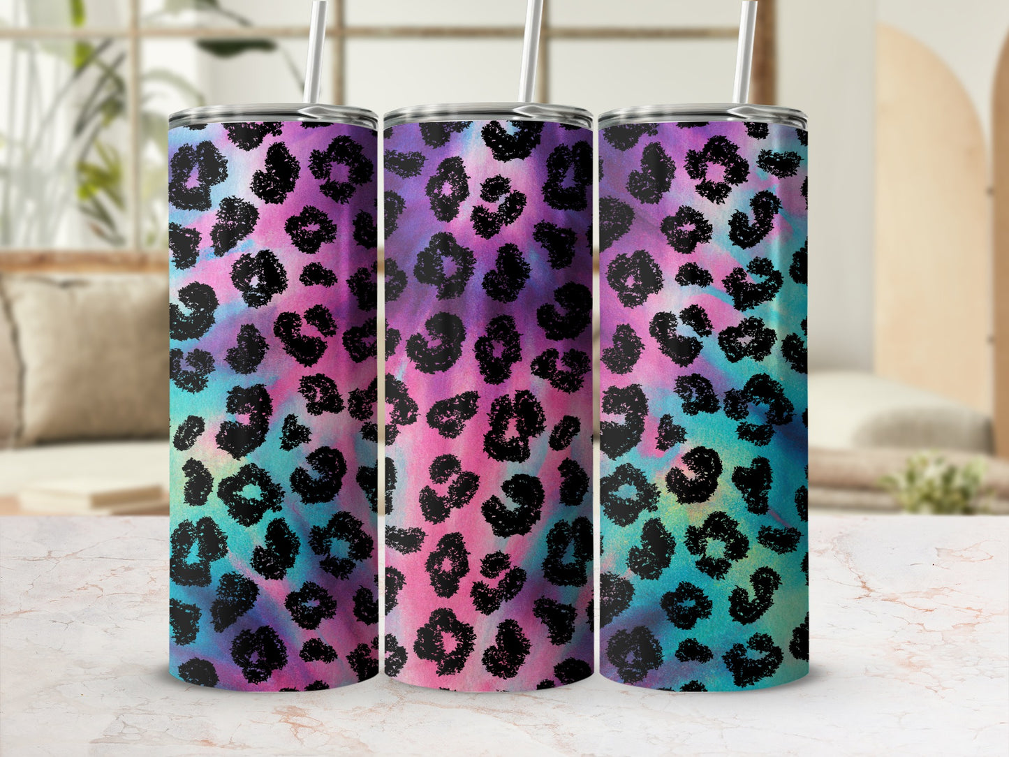 Three tumblers with rainbow tie-dye and black leopard print designs.