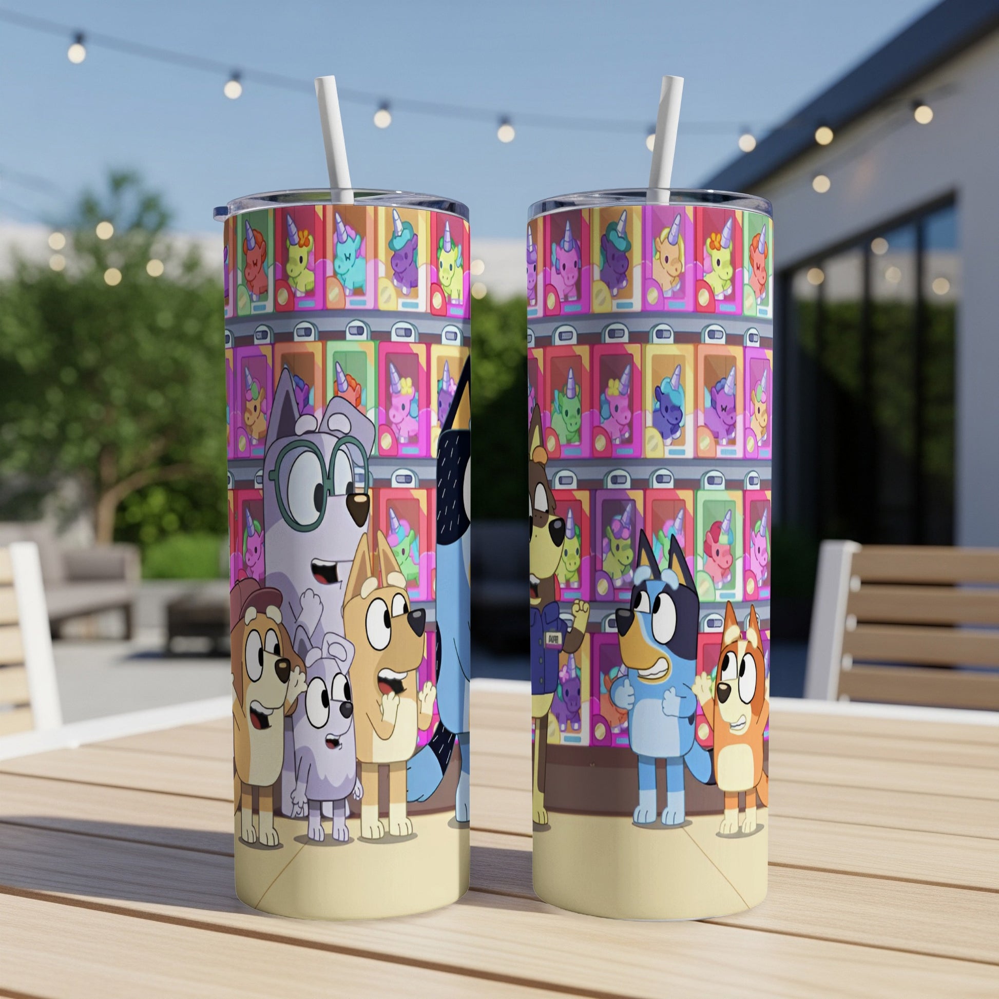 Two Bluey-themed tumblers on a table, featuring cartoon dogs and colorful vending machine prizes.
