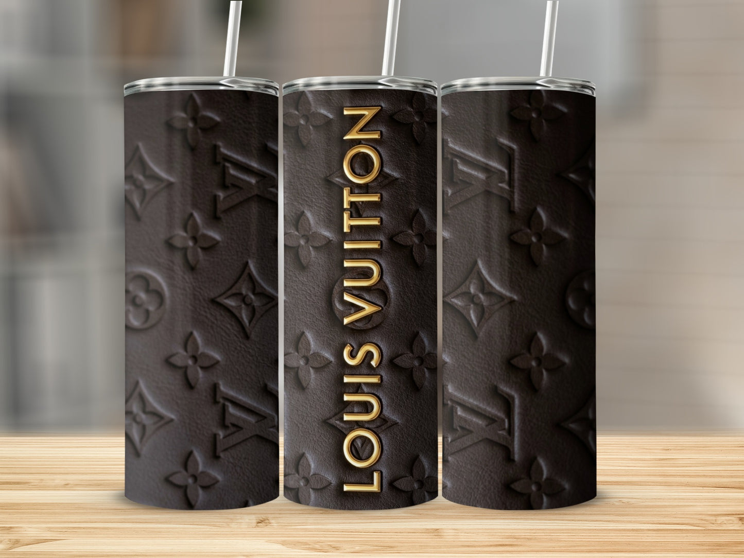 Brown tumbler with embossed Louis Vuitton logo and name.