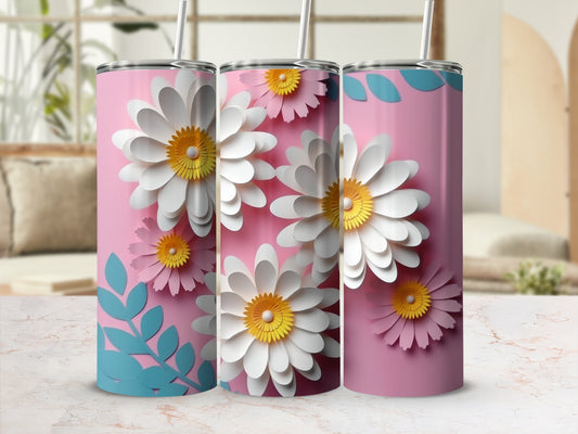 Three pink tumblers with white daisies and blue leaves, on a marble surface.
