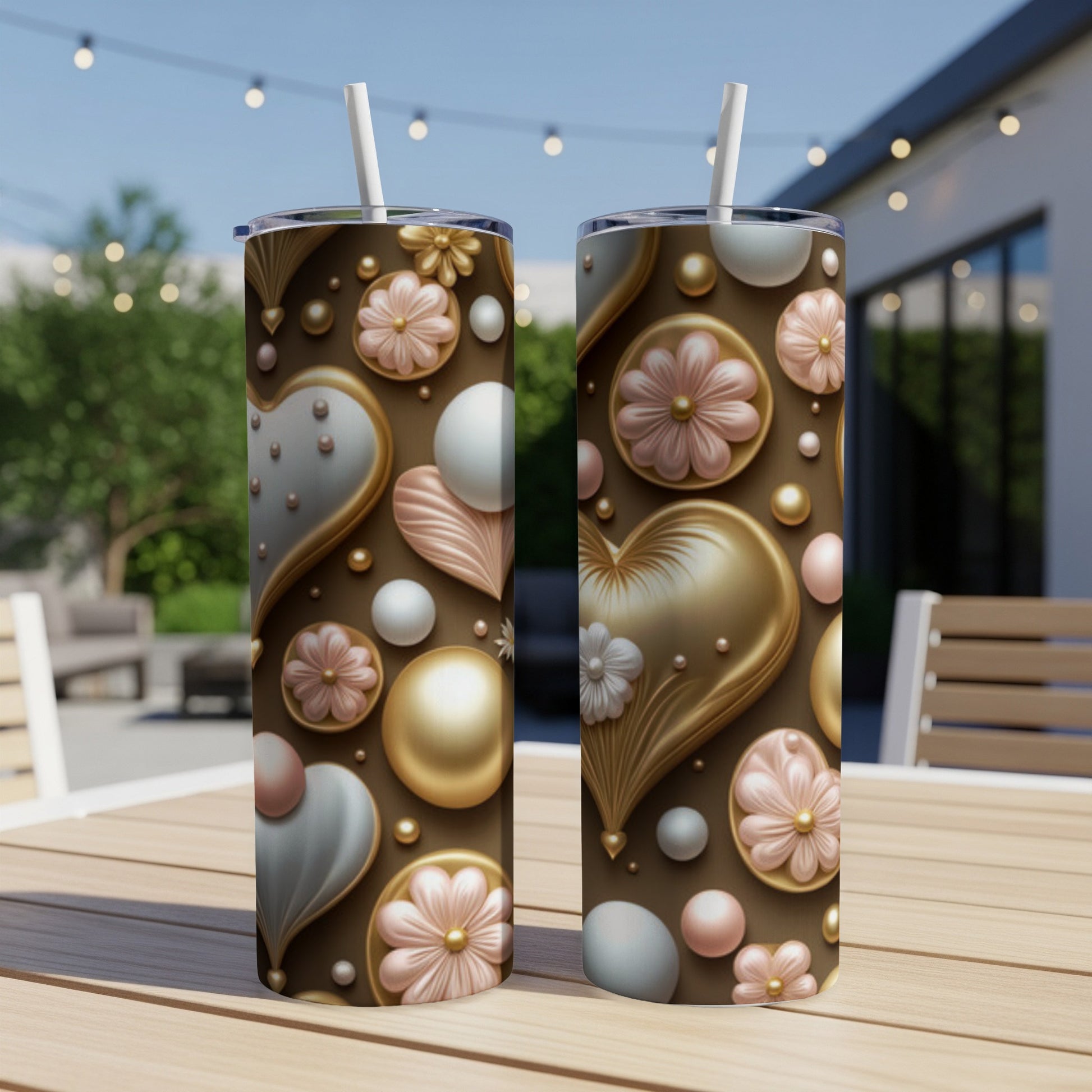 Two tall tumblers with scattered heart and floral patterns on a wooden table.