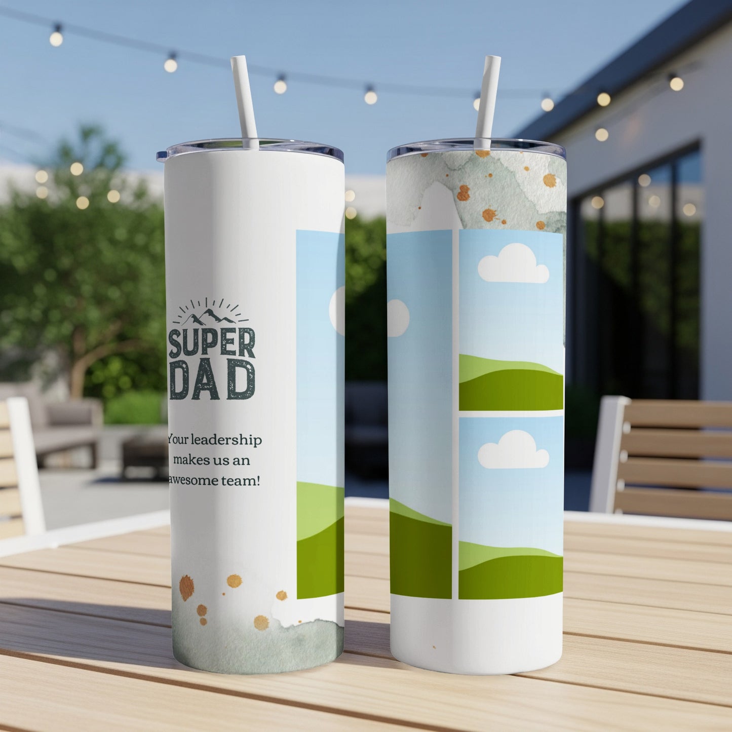 Two tumblers with "Super Dad" text and landscape images on a wooden table.