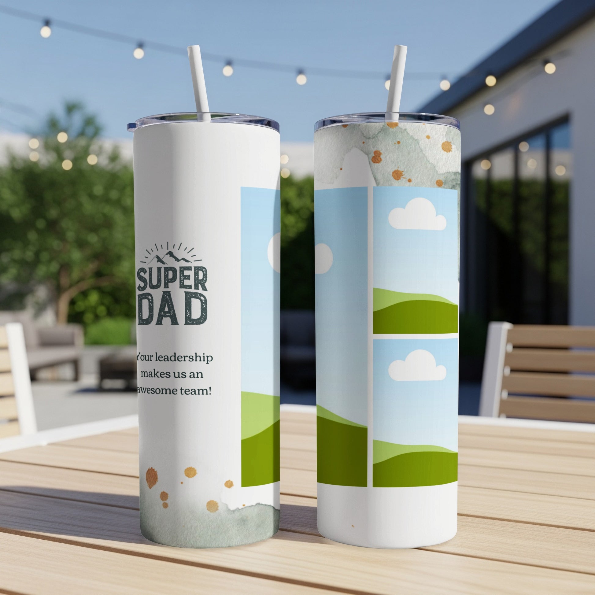 Two tumblers with "Super Dad" text and landscape images on a wooden table.