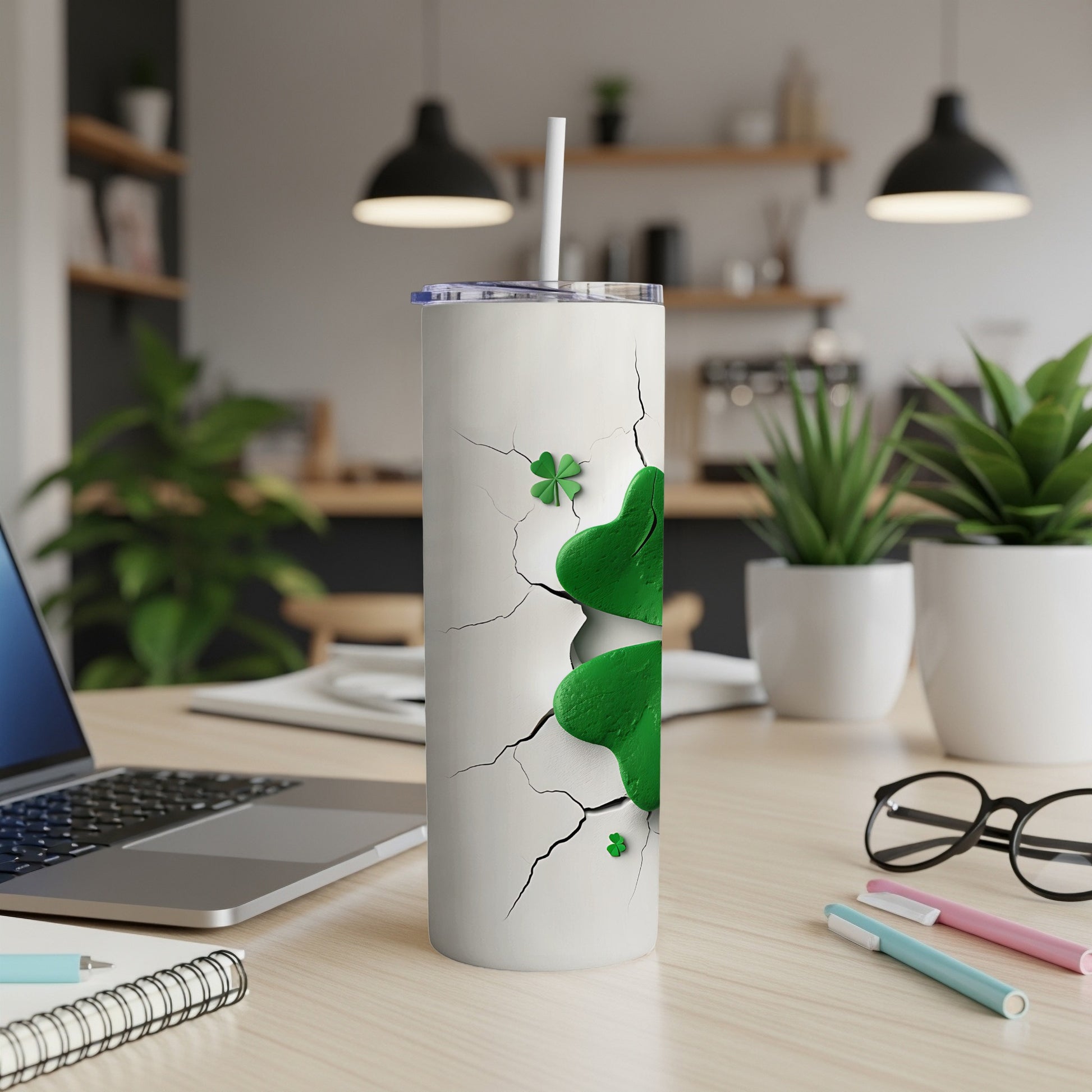 White tumbler with cracked design and green shamrocks.