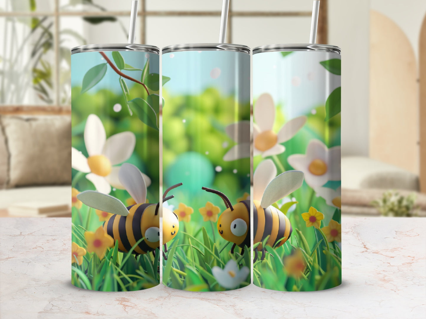 Three tumblers with a cartoon bee design in a grassy field with flowers.