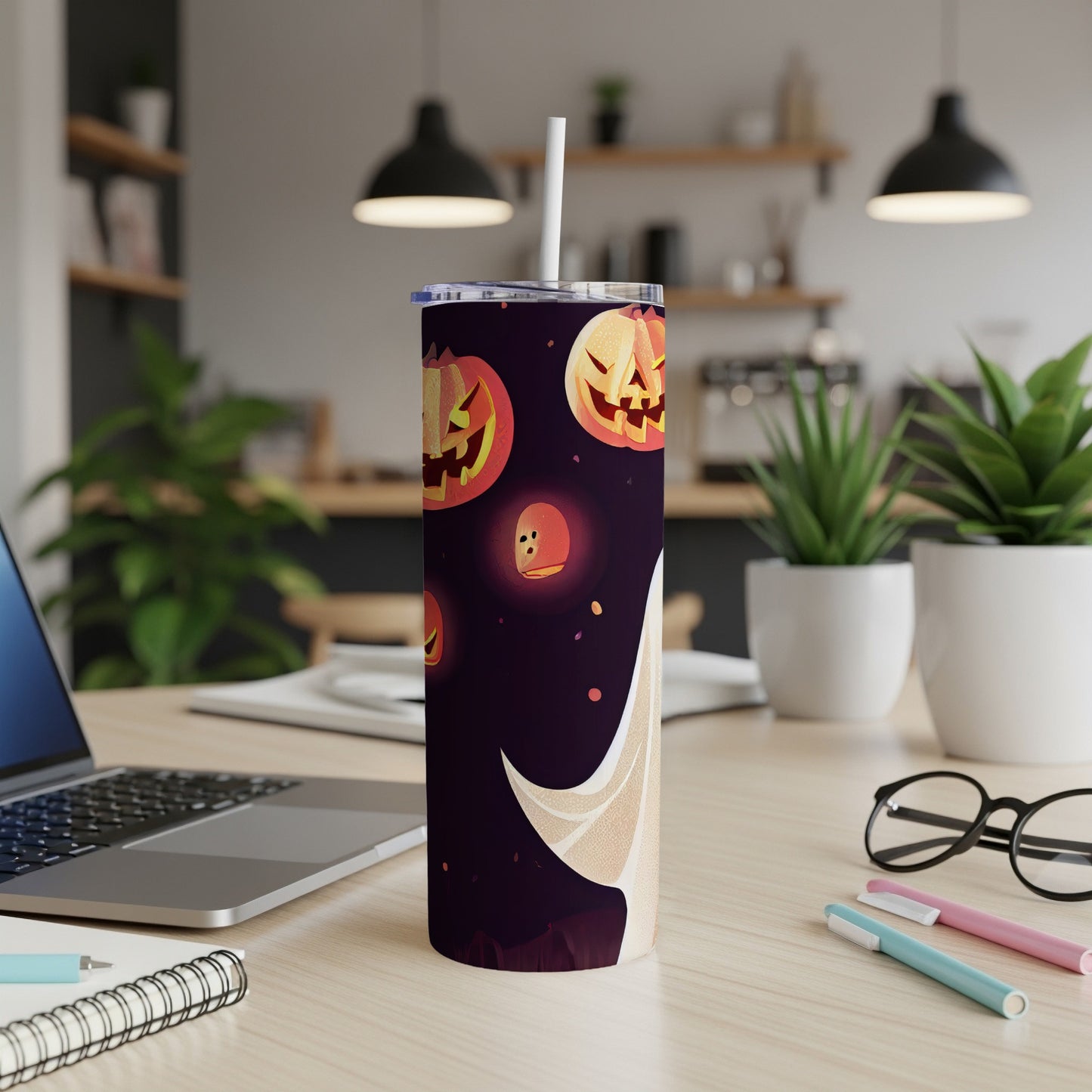 Tall tumbler with Halloween jack-o'-lantern and ghost design on dark background.
