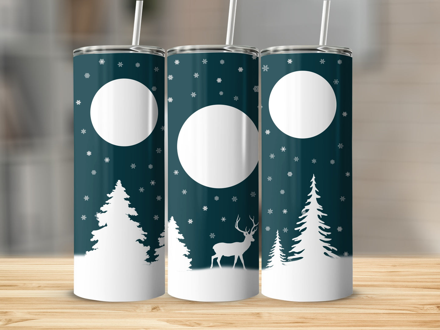 Three dark teal tumblers with a white snowy forest and deer design.