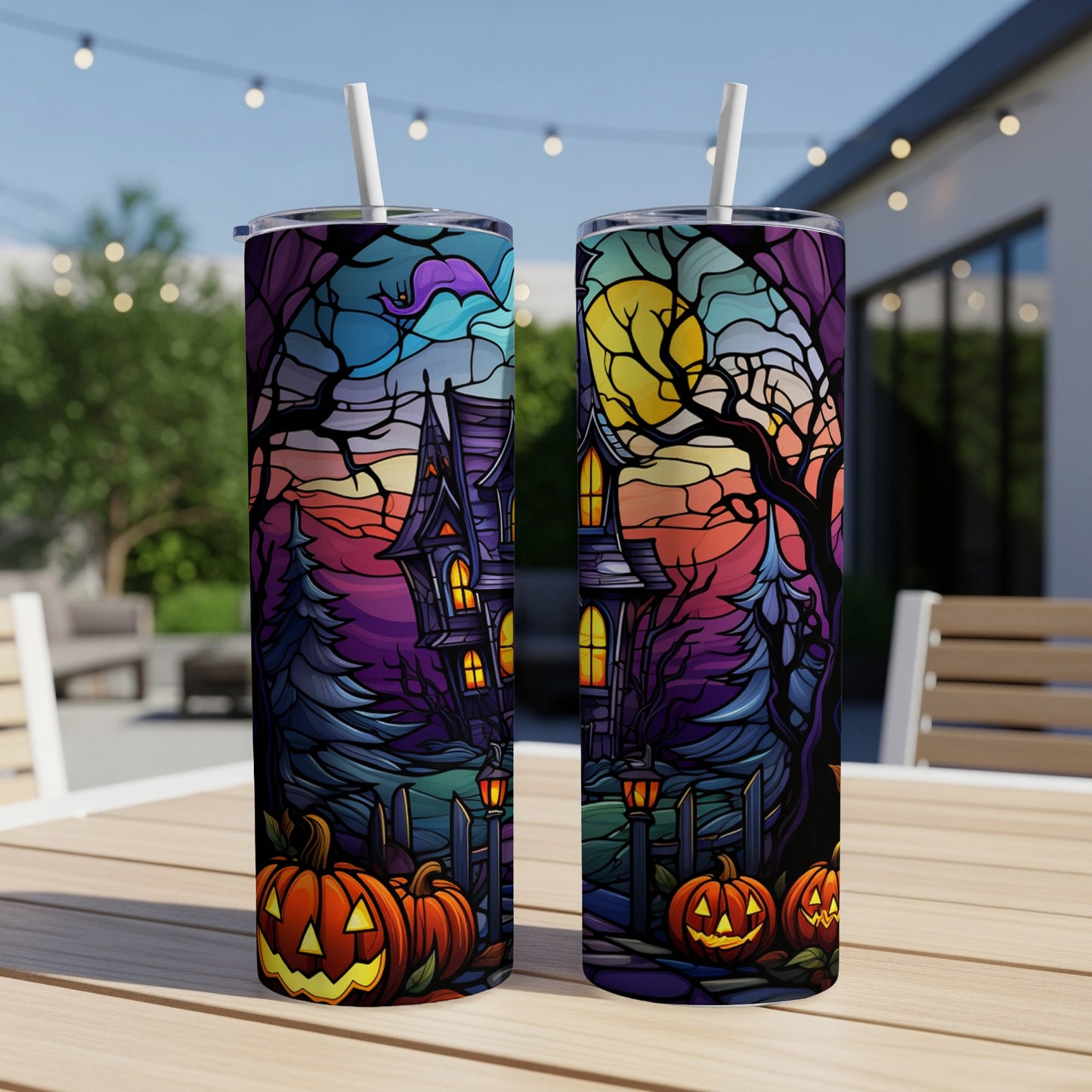 Halloween haunted house with pumpkins and moon design on two tumblers.