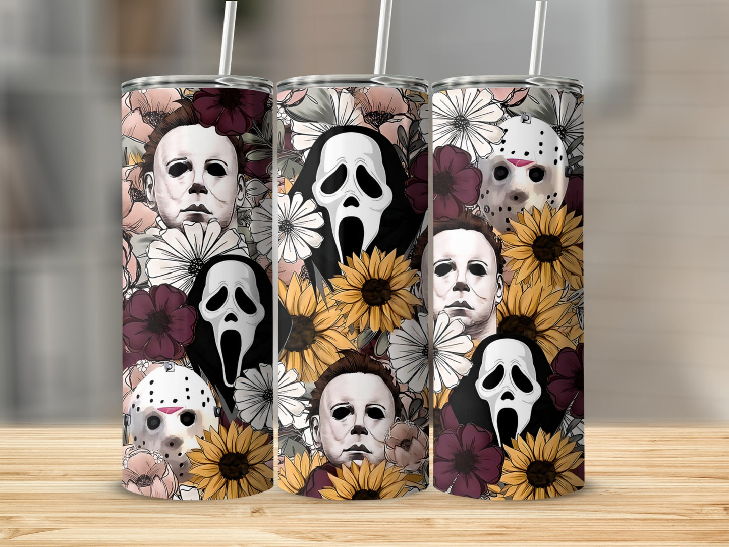 Three tumblers with horror characters and floral patterns.