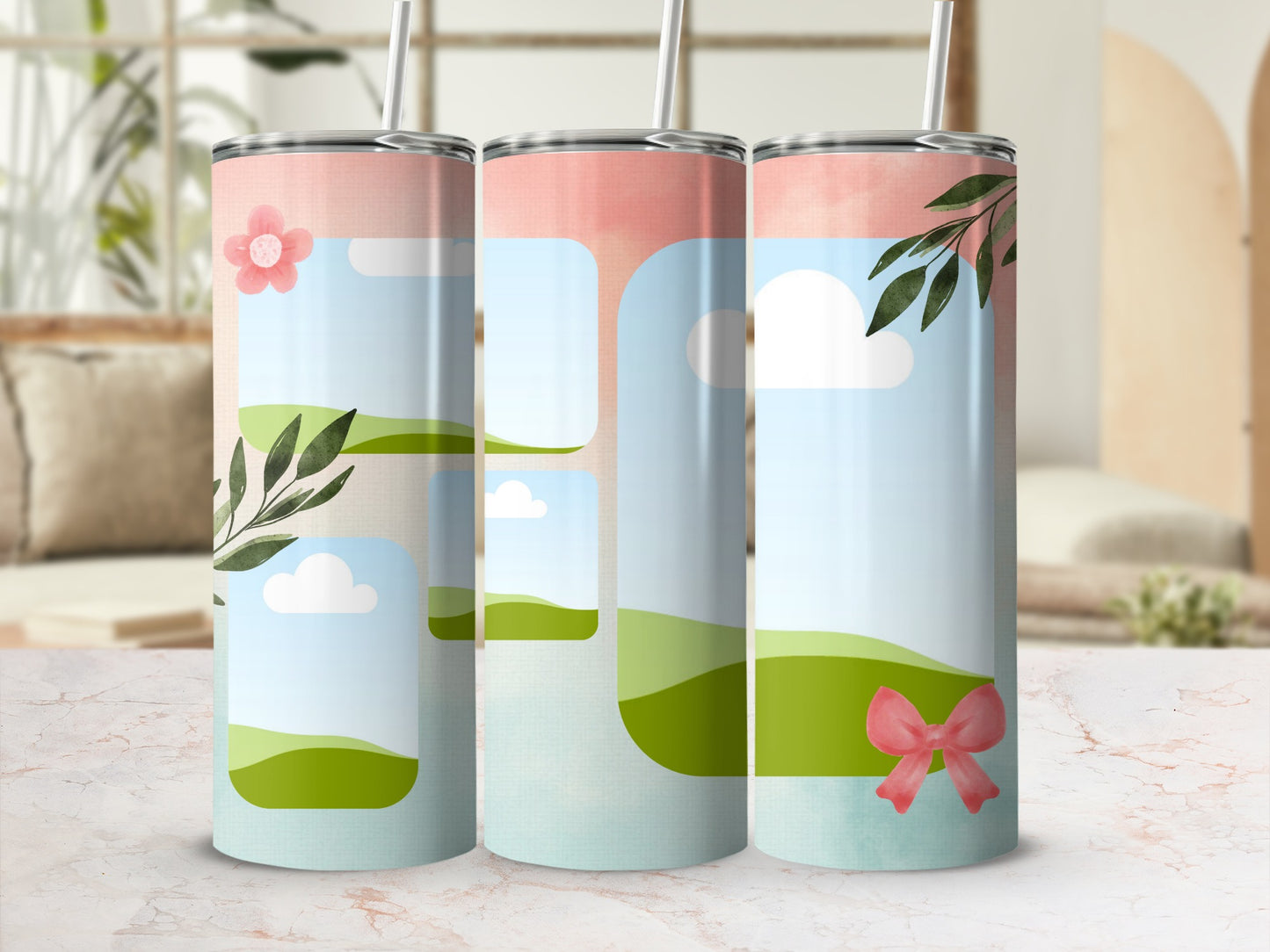 Three tumblers with pastel landscape designs featuring flowers, leaves, and bows.