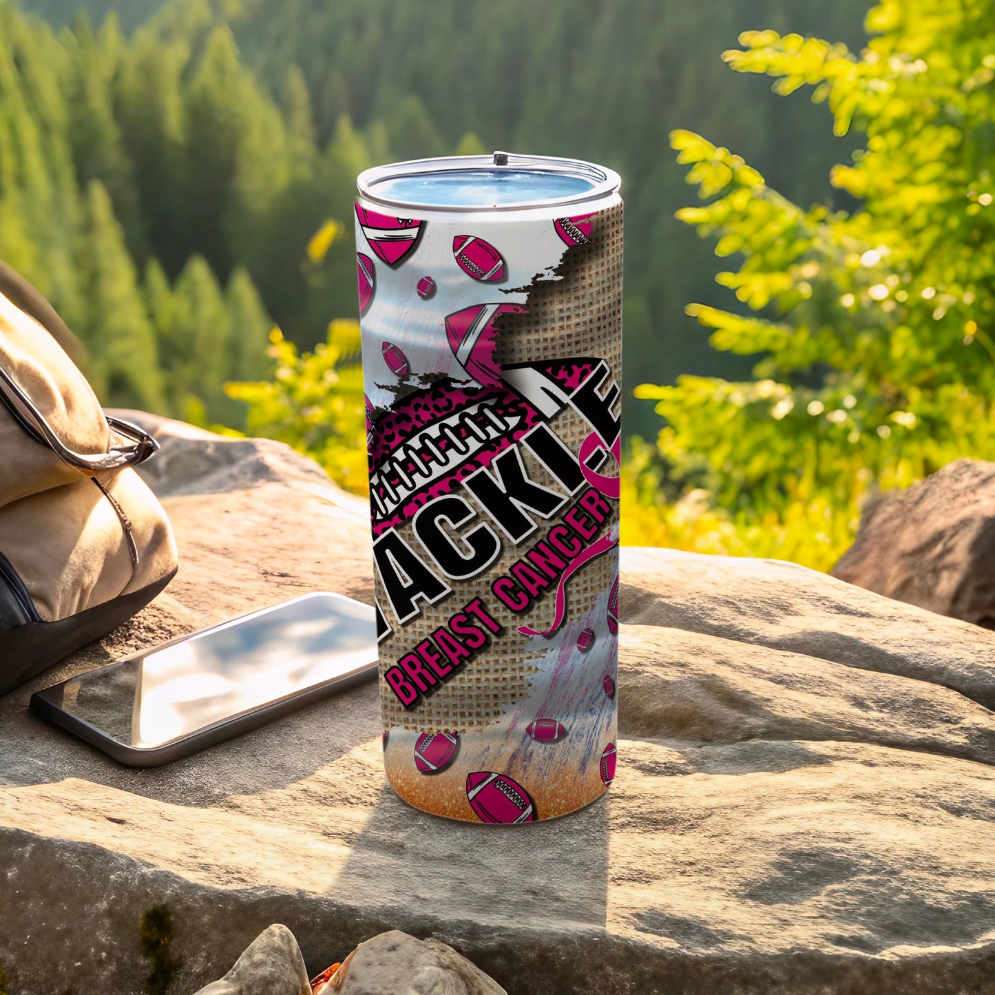 Pink football pattern tumbler with "TACKLE BREAST CANCER" text.