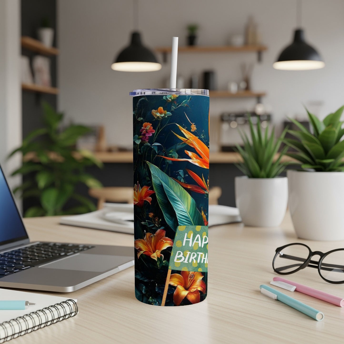 Tall tumbler with floral pattern, straw, and "Happy Birthday" sign.