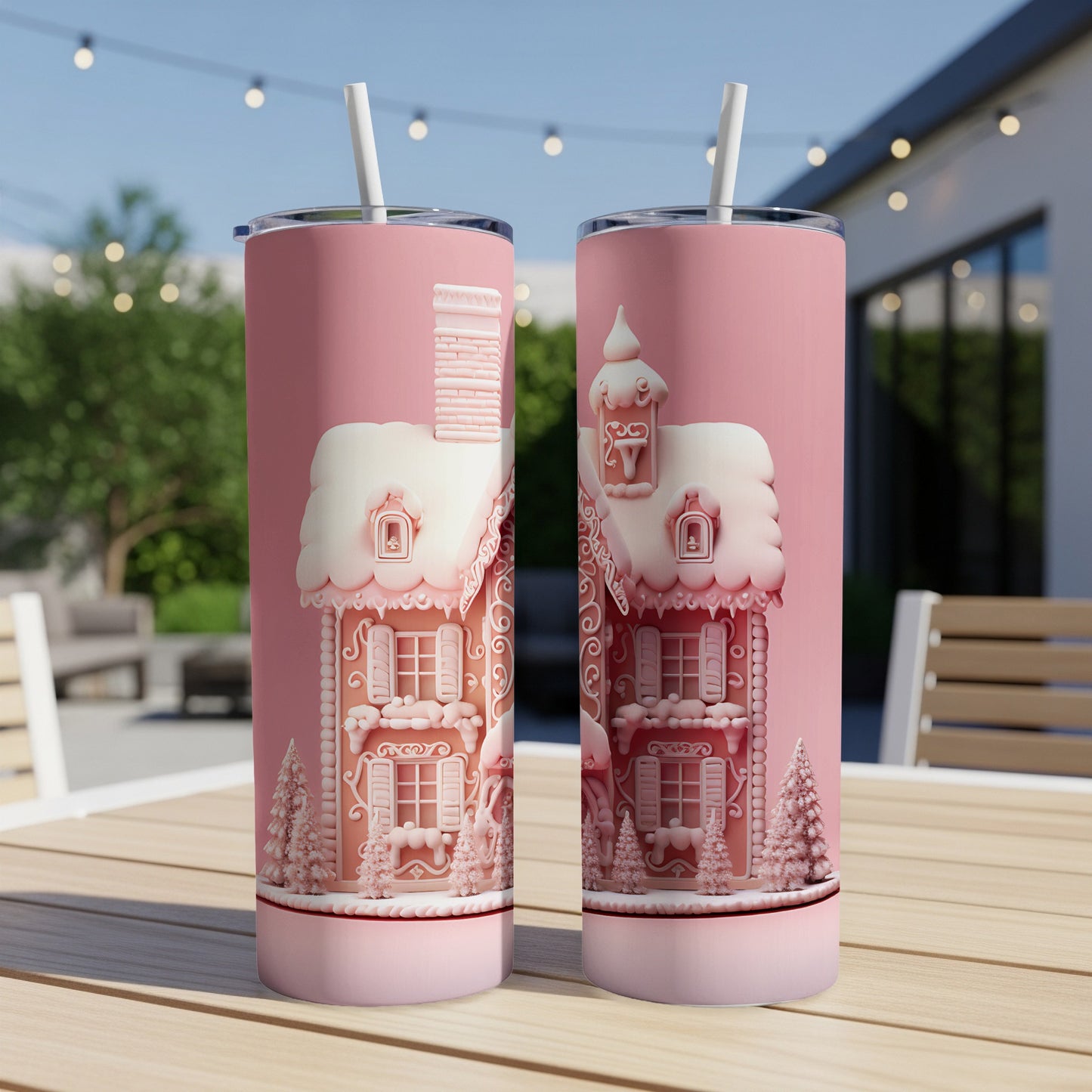 Pink gingerbread house tumbler with chimney and snow on roof.