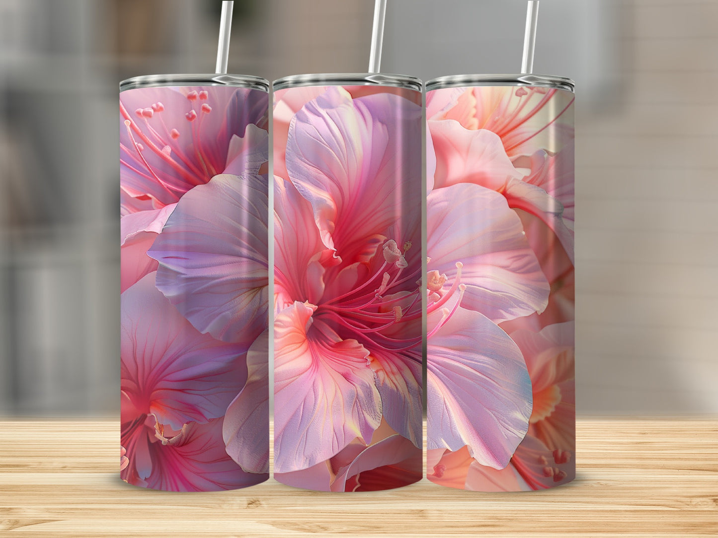 Three tumblers with large pink hibiscus flowers and white straws.