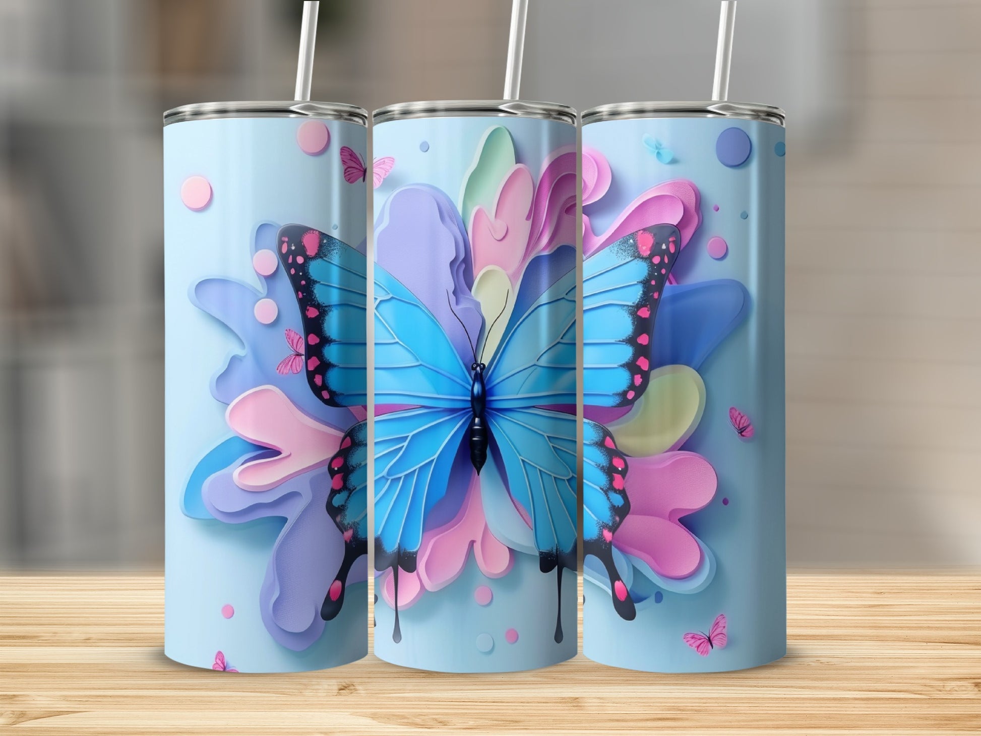 Three light blue tumblers with blue butterfly and pastel floral designs.