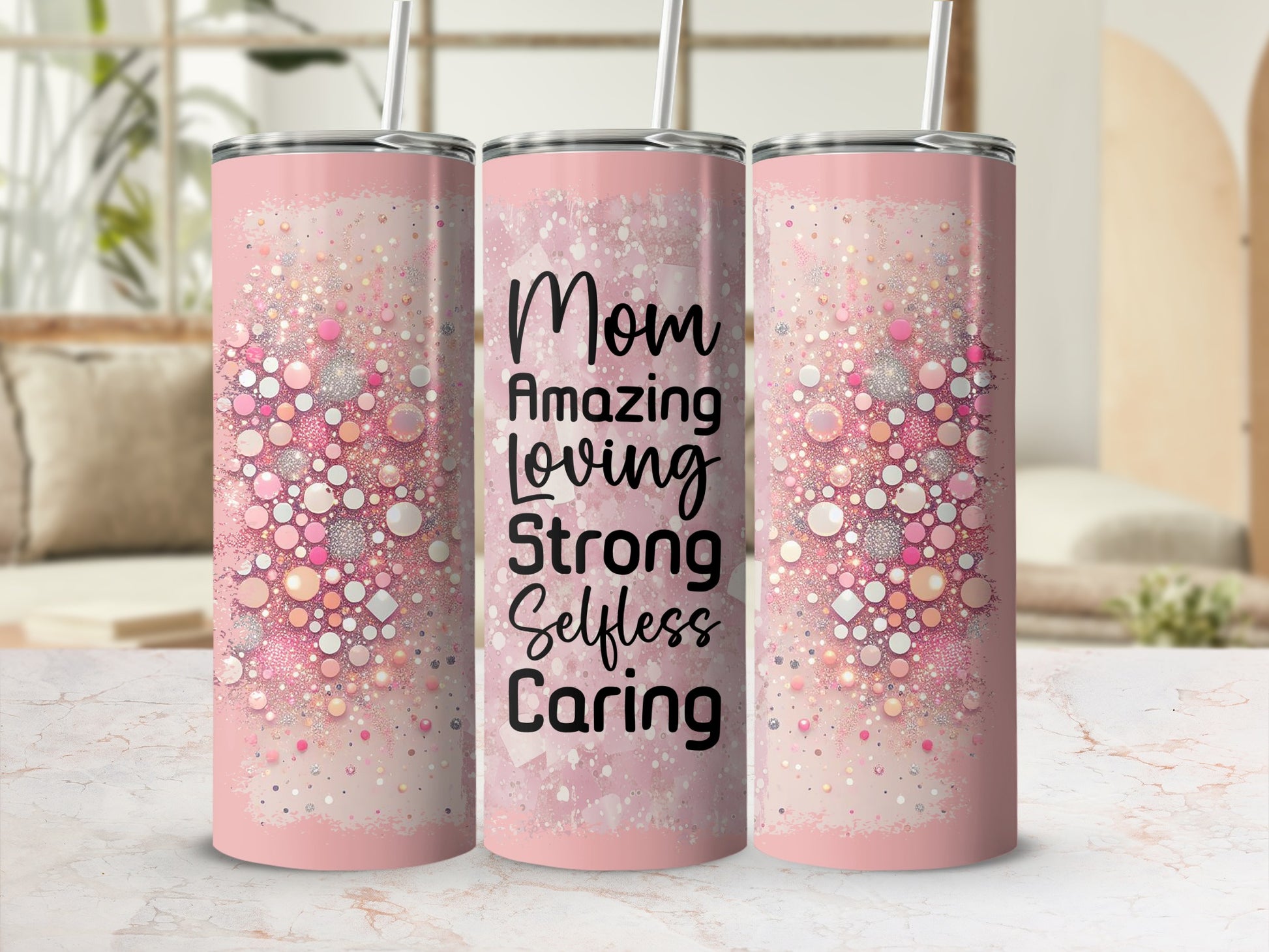 Pink tumbler with "Mom Amazing Loving Strong Selfless Caring" text and glitter accents.