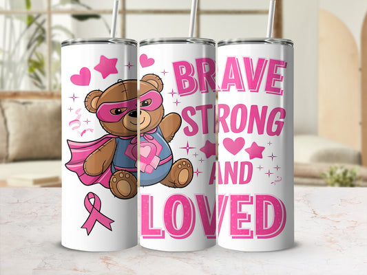 Pink teddy bear superhero and "BRAVE STRONG LOVED" text on tumbler.