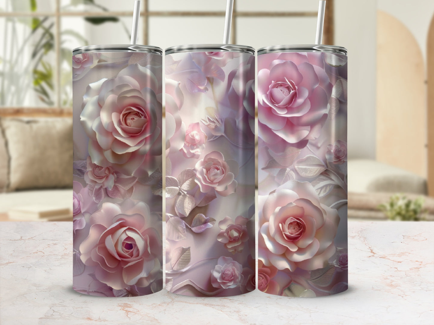 Three tall, slender tumblers adorned with embossed pink roses on a marble surface.