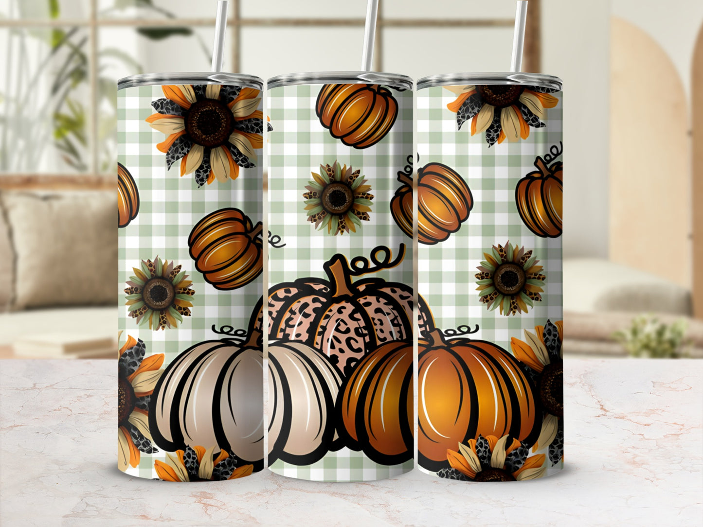 Three tumblers with pumpkins and sunflowers on a checkered background.