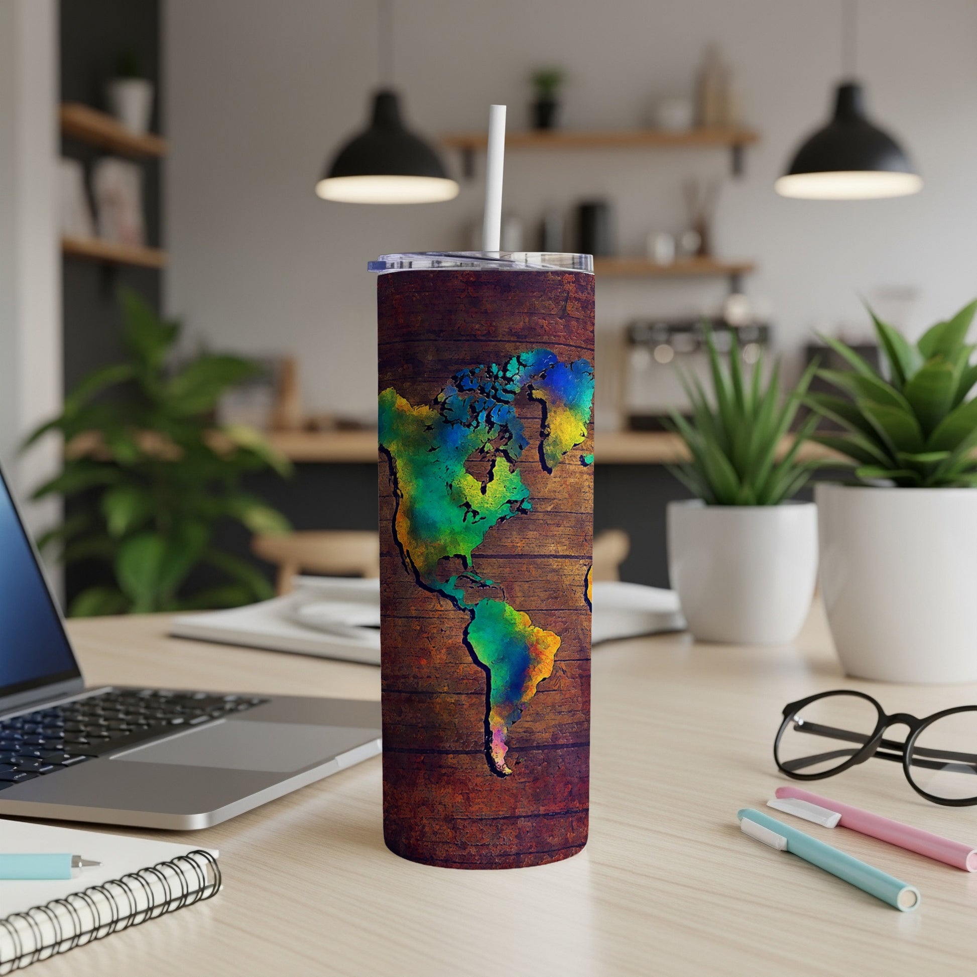 Tumbler with colorful Americas map design on wood grain texture.