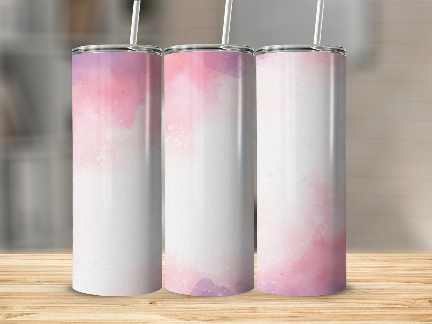 Three tall, skinny tumblers with pink and purple watercolor designs.
