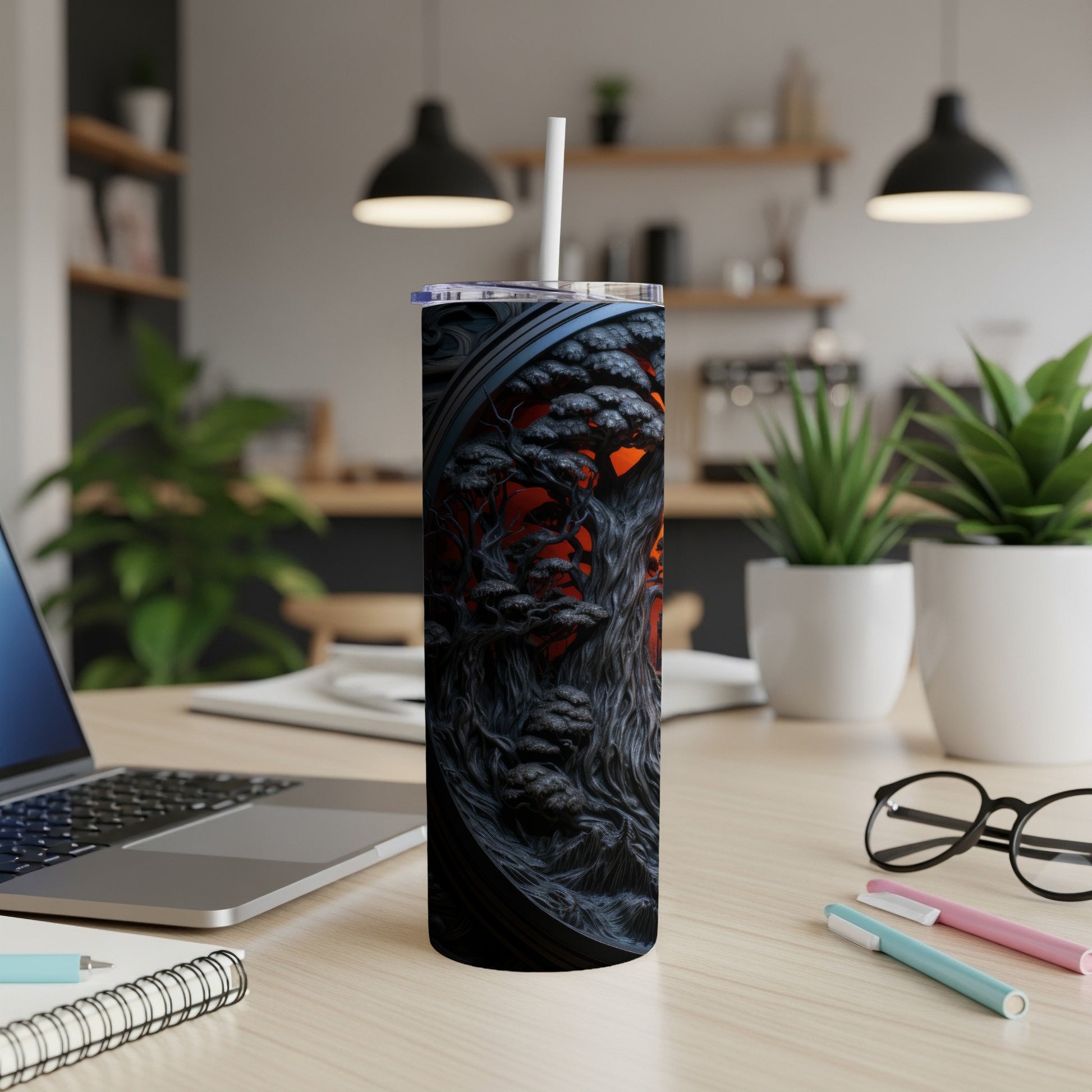 Dark tumbler with a gothic tree design and a white straw.