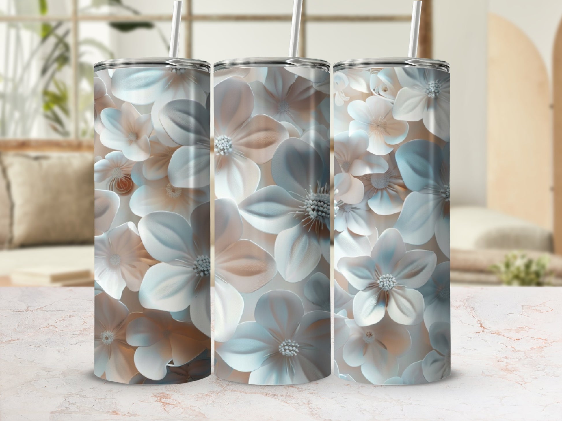 Three tall tumblers with floral pattern against a blurred background.