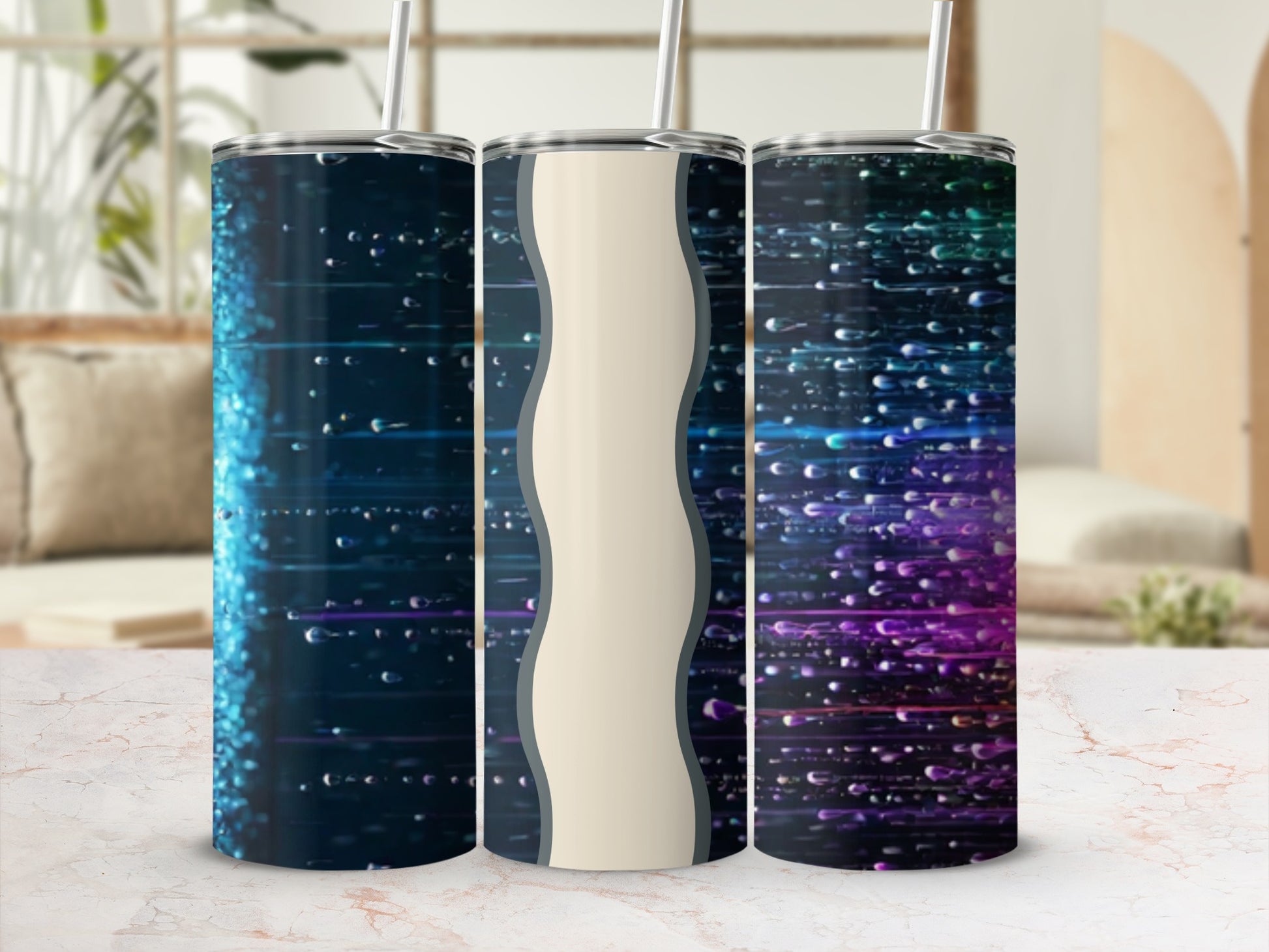 Three insulated tumblers with abstract, colorful, light-streaked designs.