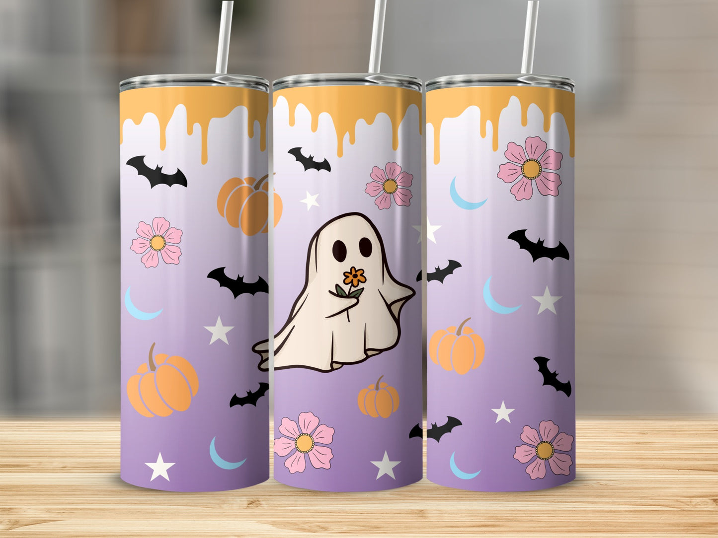 Three tumblers with a purple gradient, featuring a ghost, pumpkins, flowers, bats, moons, and stars.