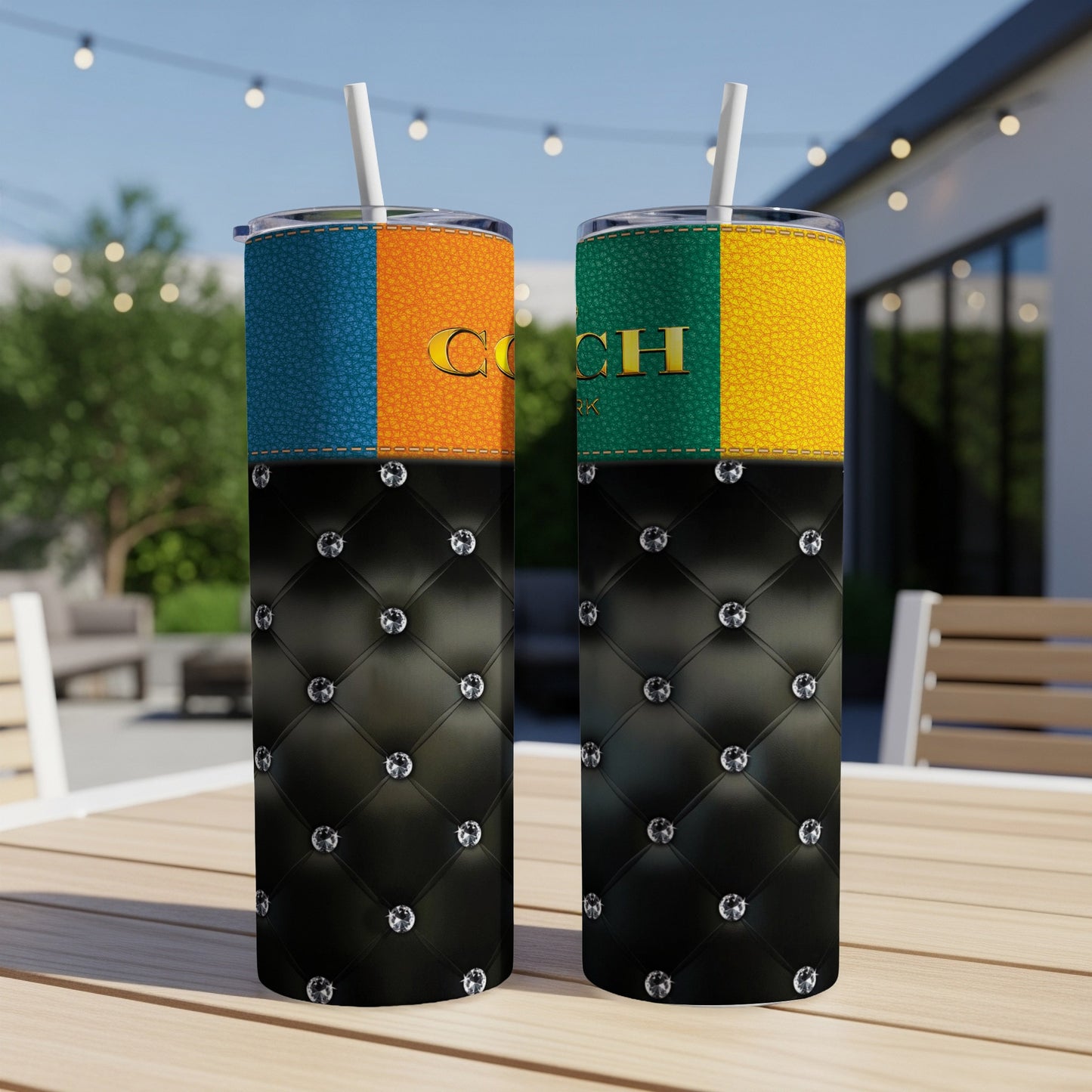 Two tumblers with quilted black bottoms, colored leather tops, and gold lettering that reads "COACH".