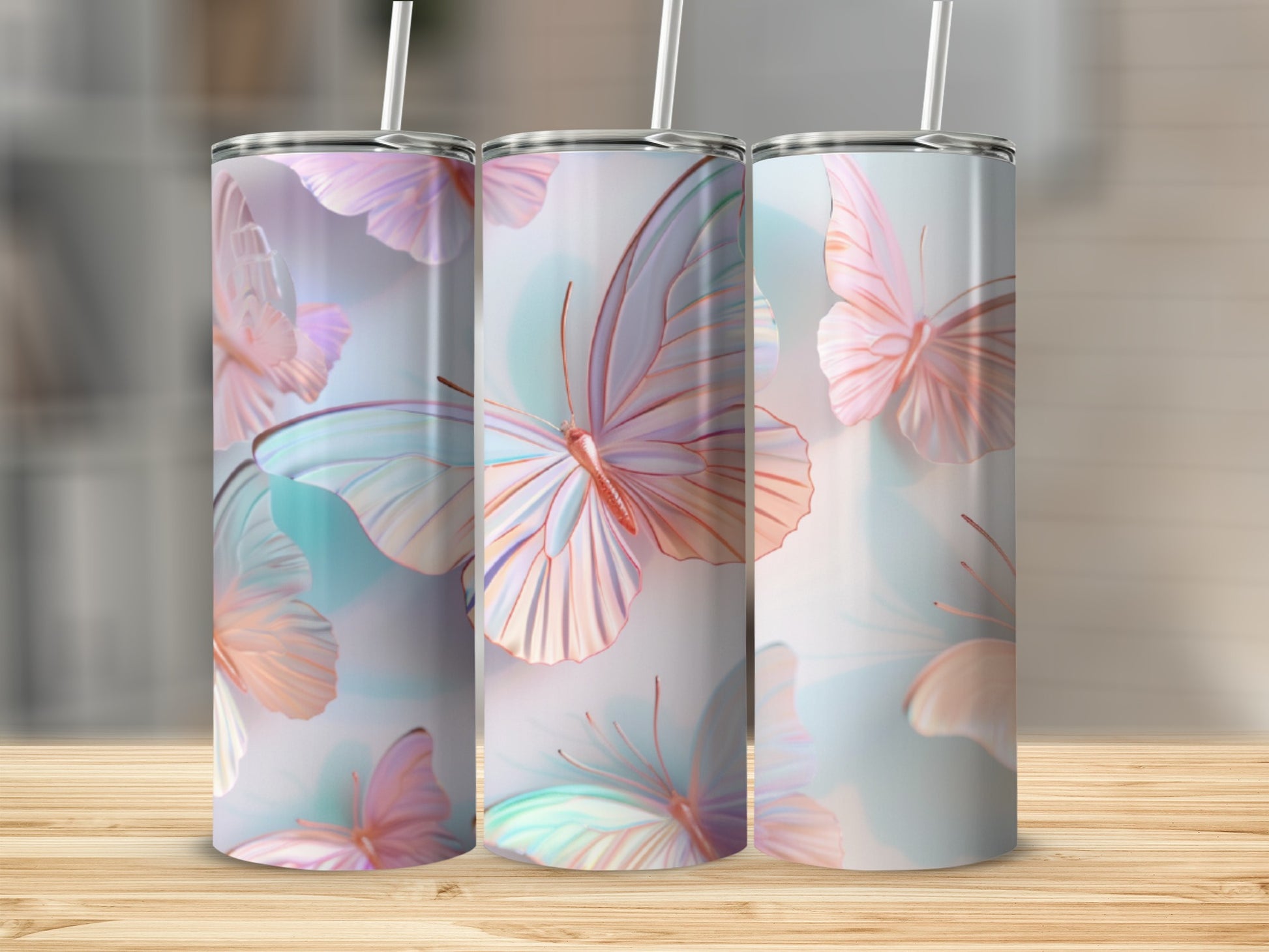 Three tumblers featuring iridescent butterfly designs and straws.