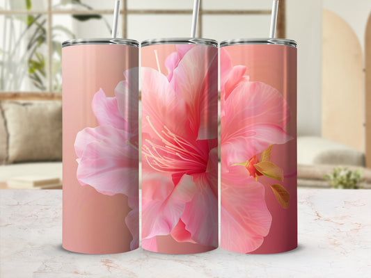 Three pink floral tumblers with straws arranged on a counter.