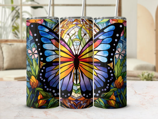 Stained glass butterfly design on three tumblers with straws.
