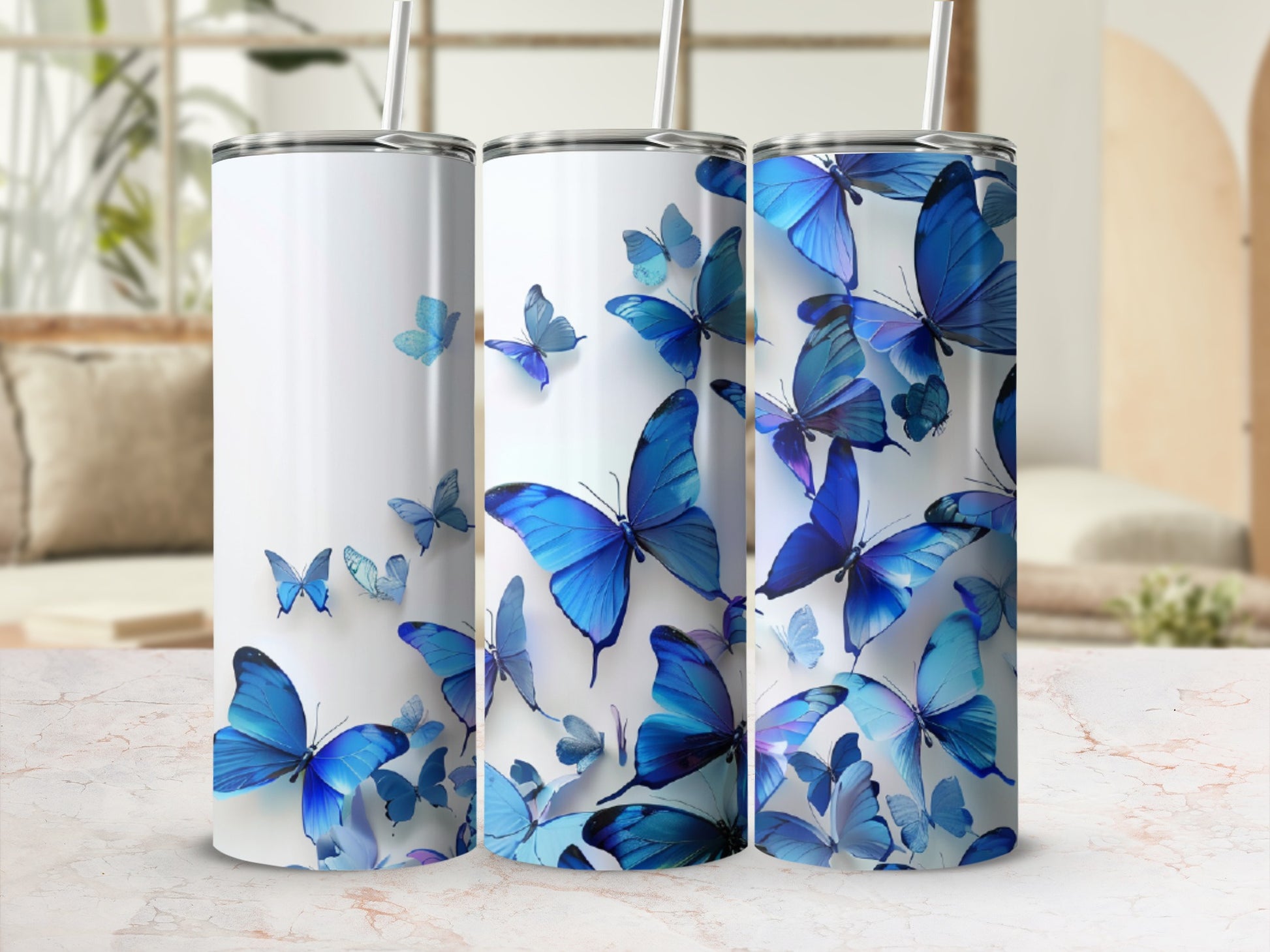 Three tumblers featuring a collage of blue butterflies against a blurred background.