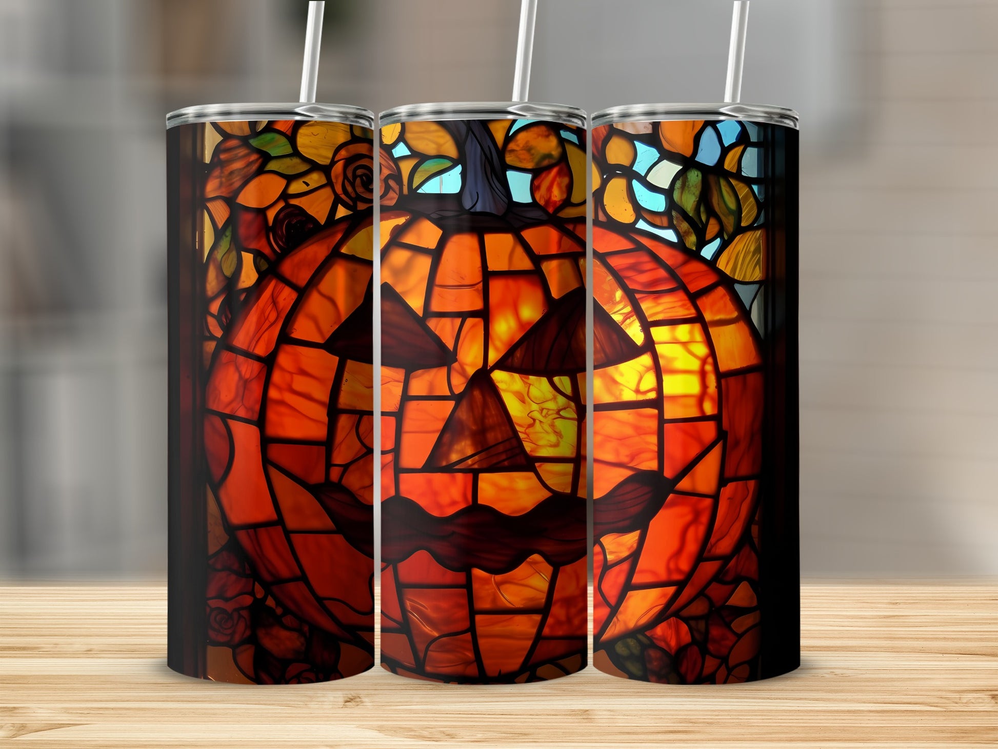 Three tumblers featuring a stained-glass jack-o'-lantern design.