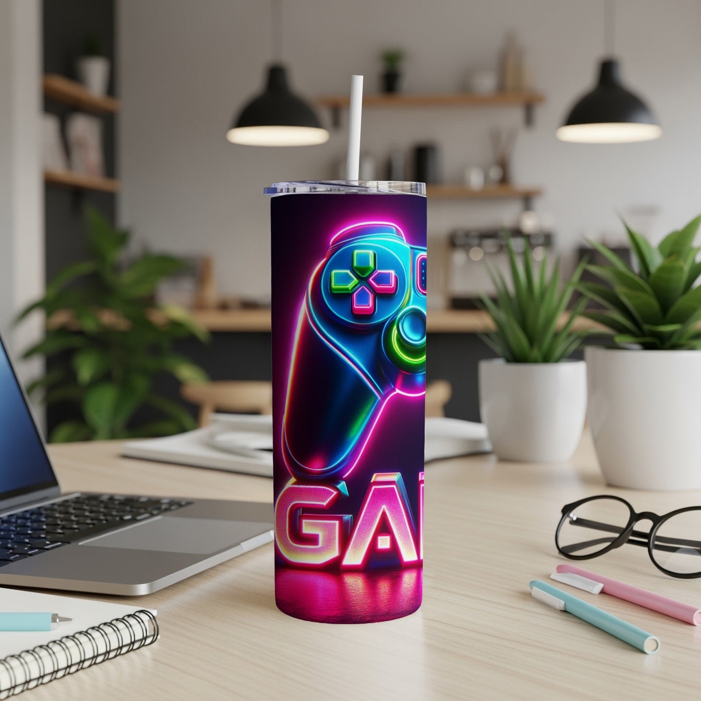 Neon "GAMING" text below a glowing video game controller on a tumbler.